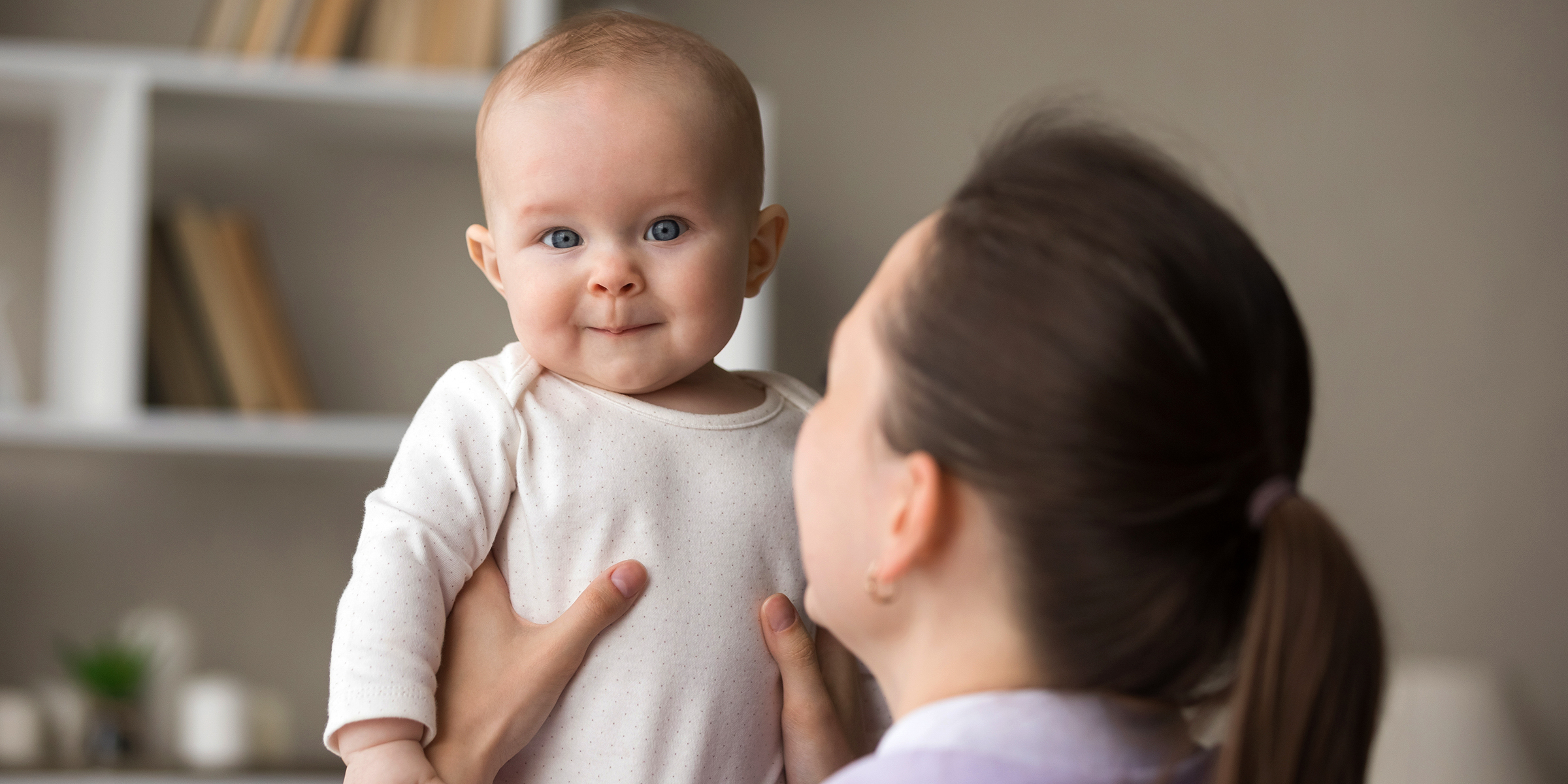 A woman holding a toddler | Source: Shutterstock