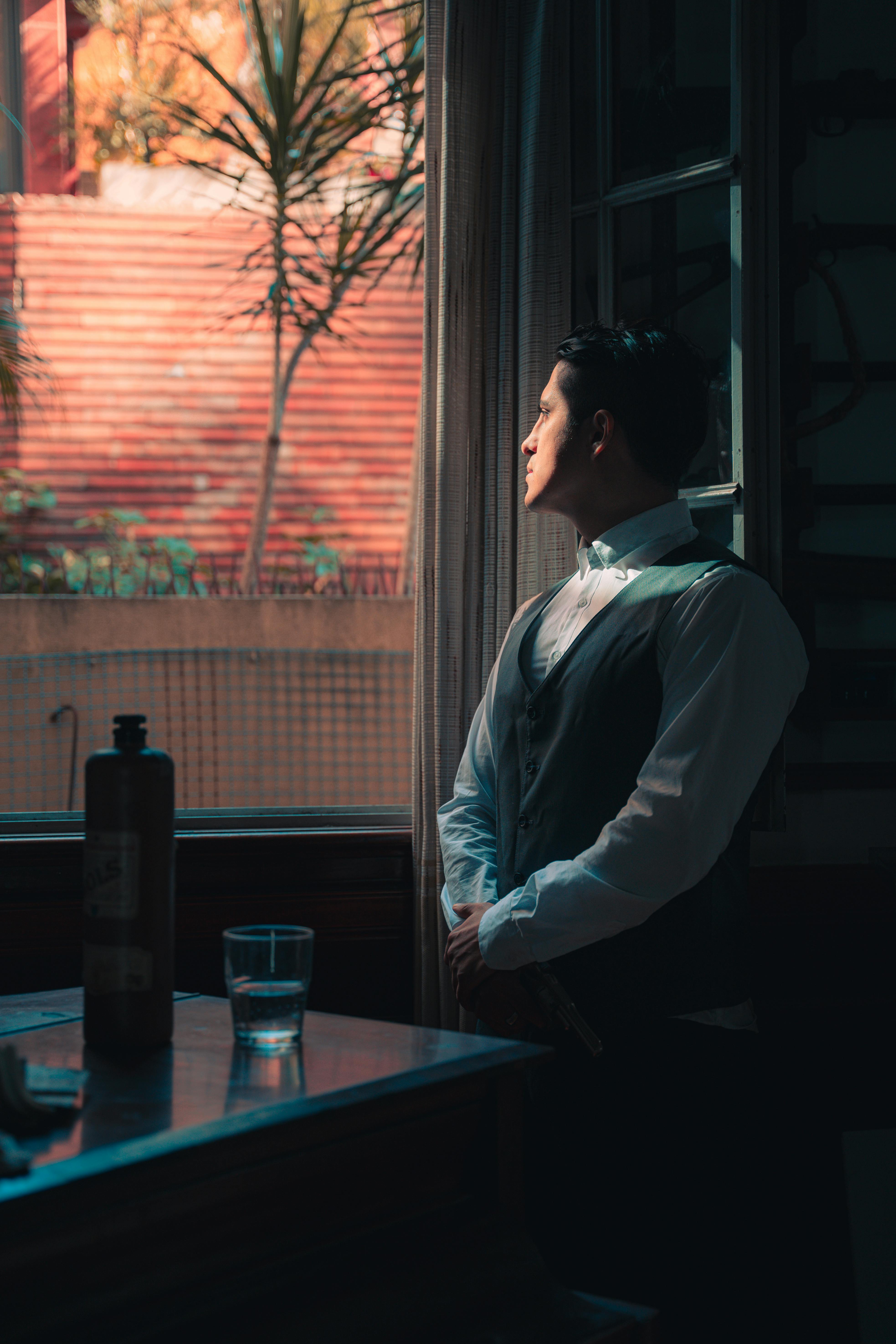 A pensive man looking out the window | Source: Pexels