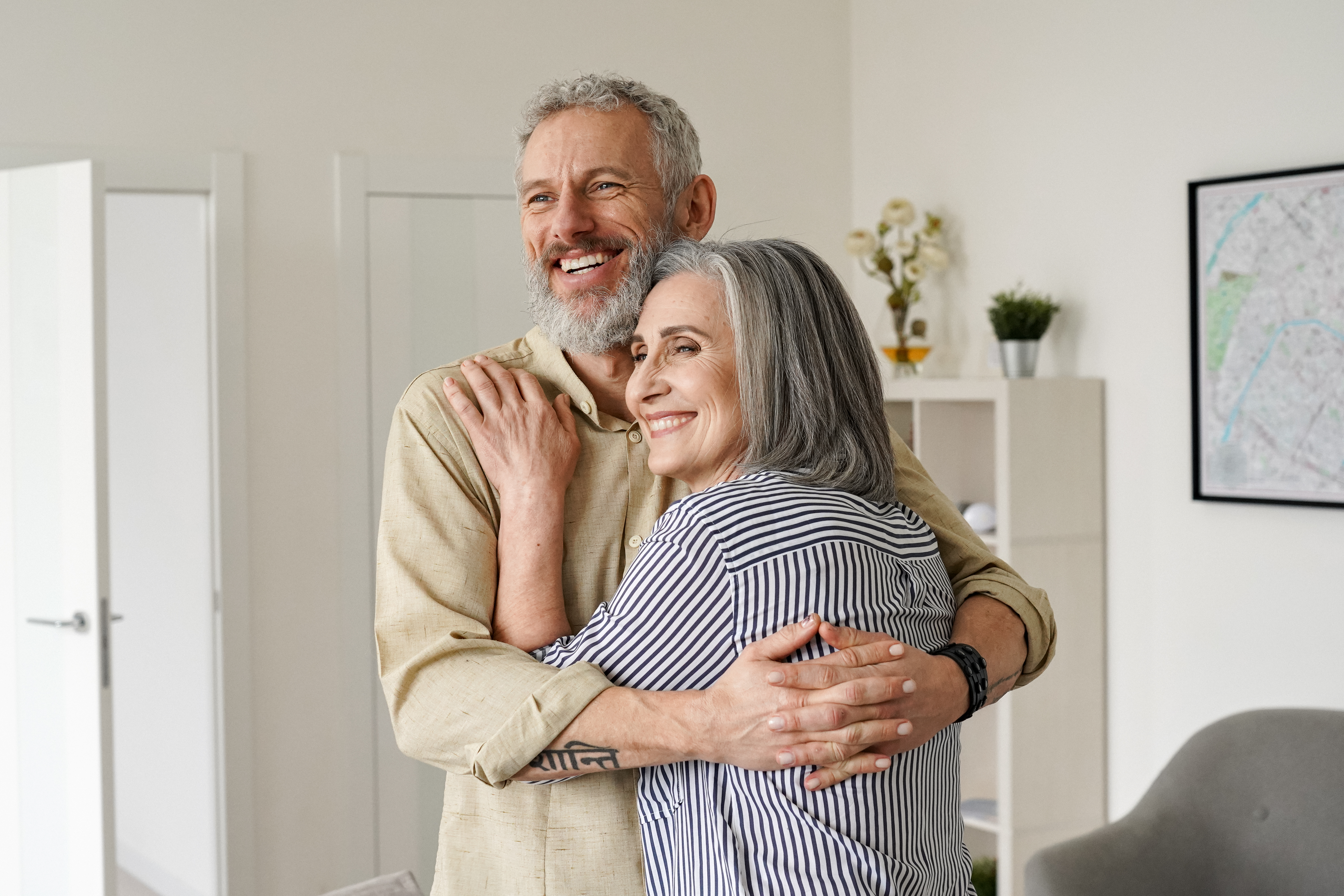 A happy senior couple hugging | Source: Shutterstock