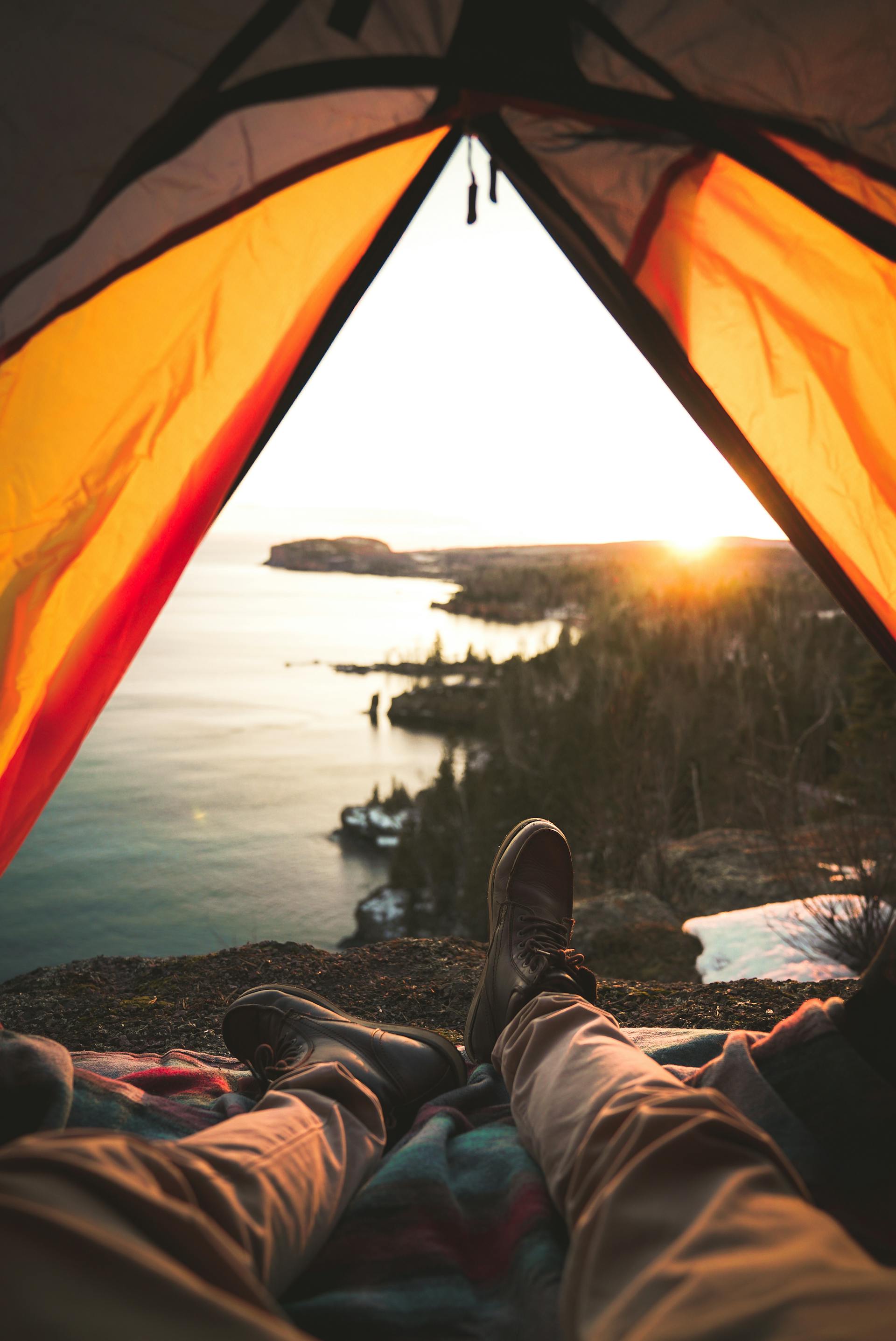 A tourist lying in a camping tent near a shore | Source: Pexels