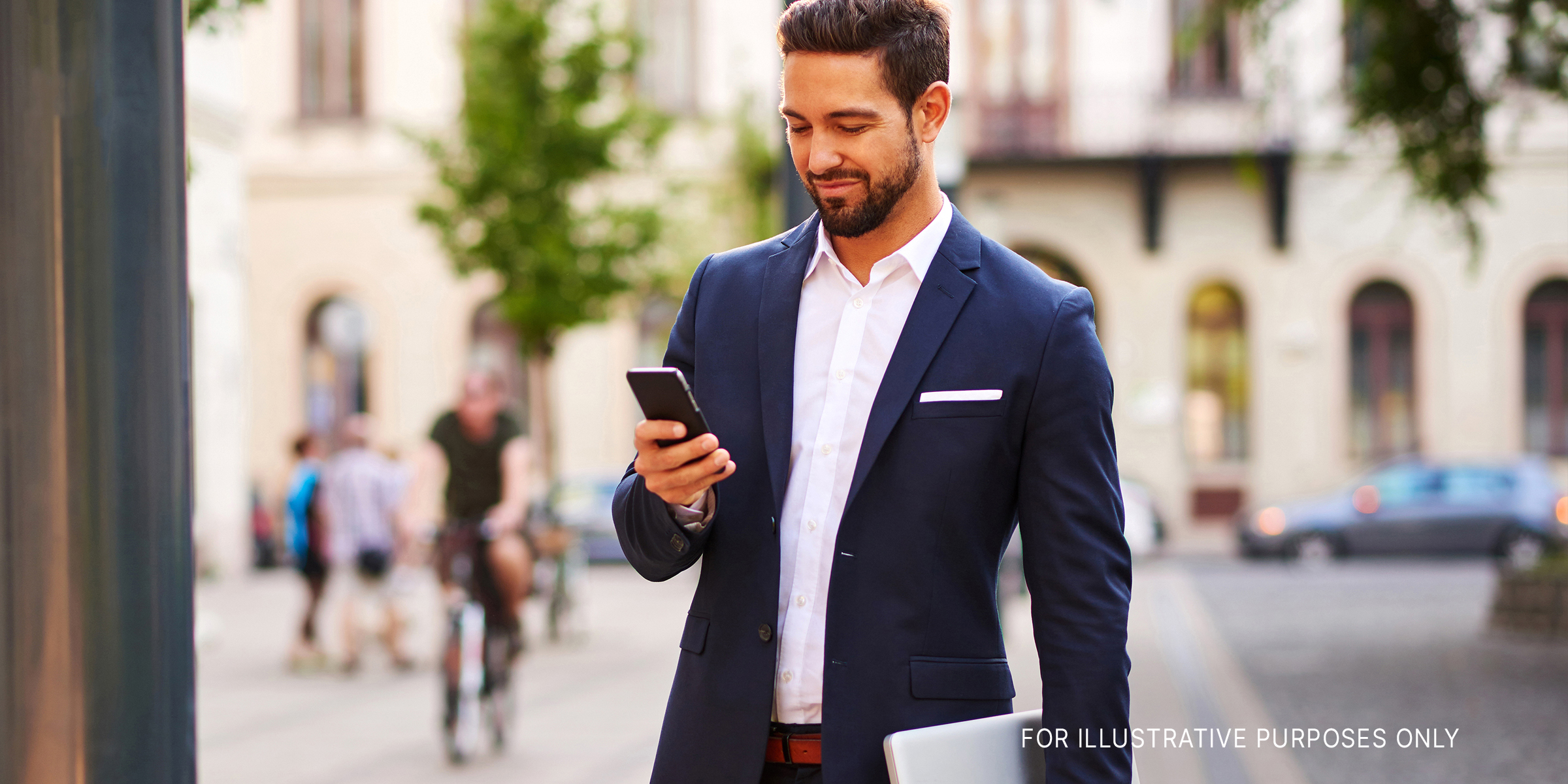 Young, good-looking businessman using the phone. | Source: Shutterstock
