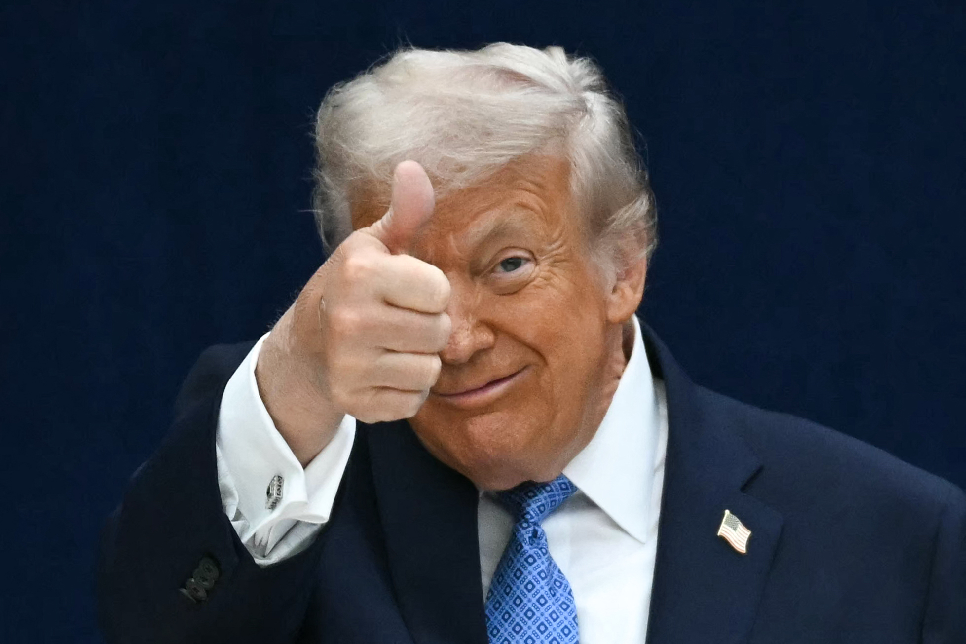Donald Trump giving a thumbs up with a bandaged hand during the signing ceremony of a peace deal with the President of Rwanda Paul Kagame in Washington, D.C., on December 4, 2025. | Source: Getty Images
