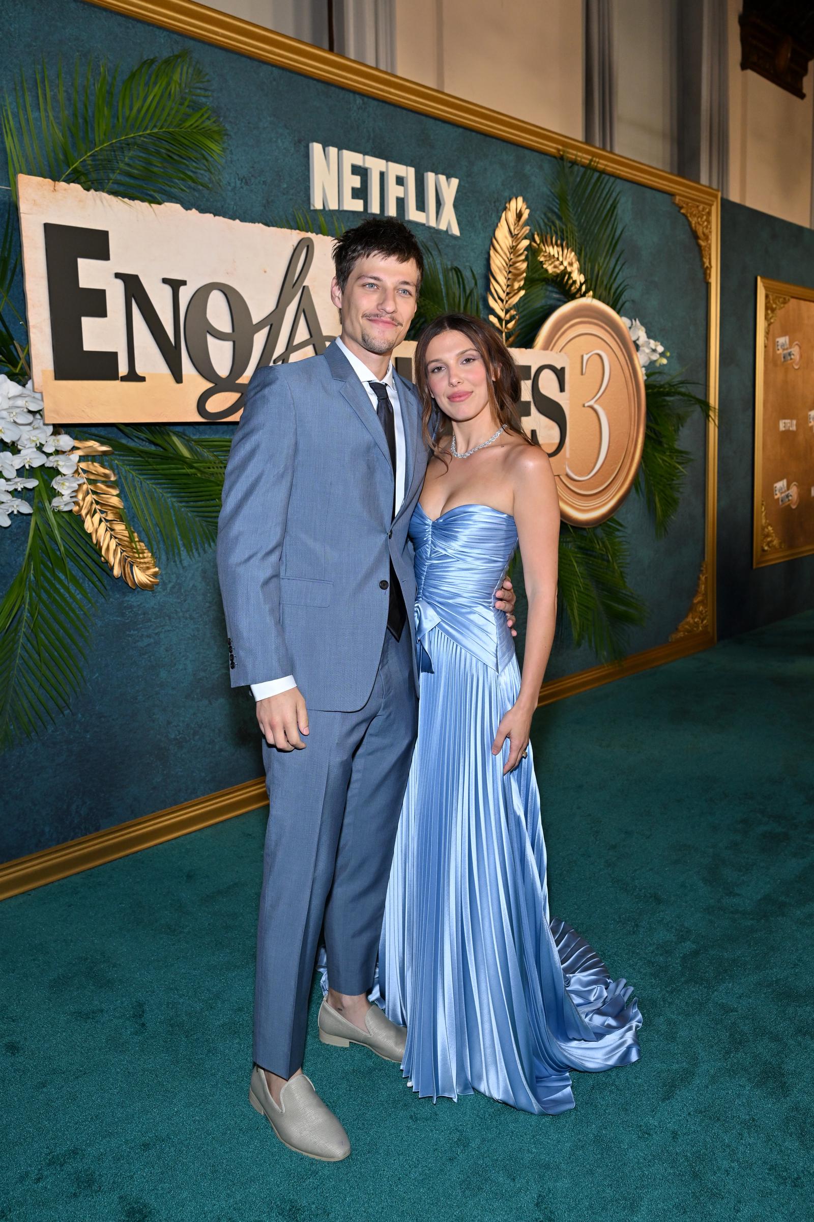 Millie Bobby Brown and Jake Bongiovi pose together at the "Enola Holmes 3" New York premiere. Their coordinated blue outfits quickly drew attention online, with social media users sharing a wide range of opinions about Brown's gown and Bongiovi's tailored suit. | Source: Getty Images