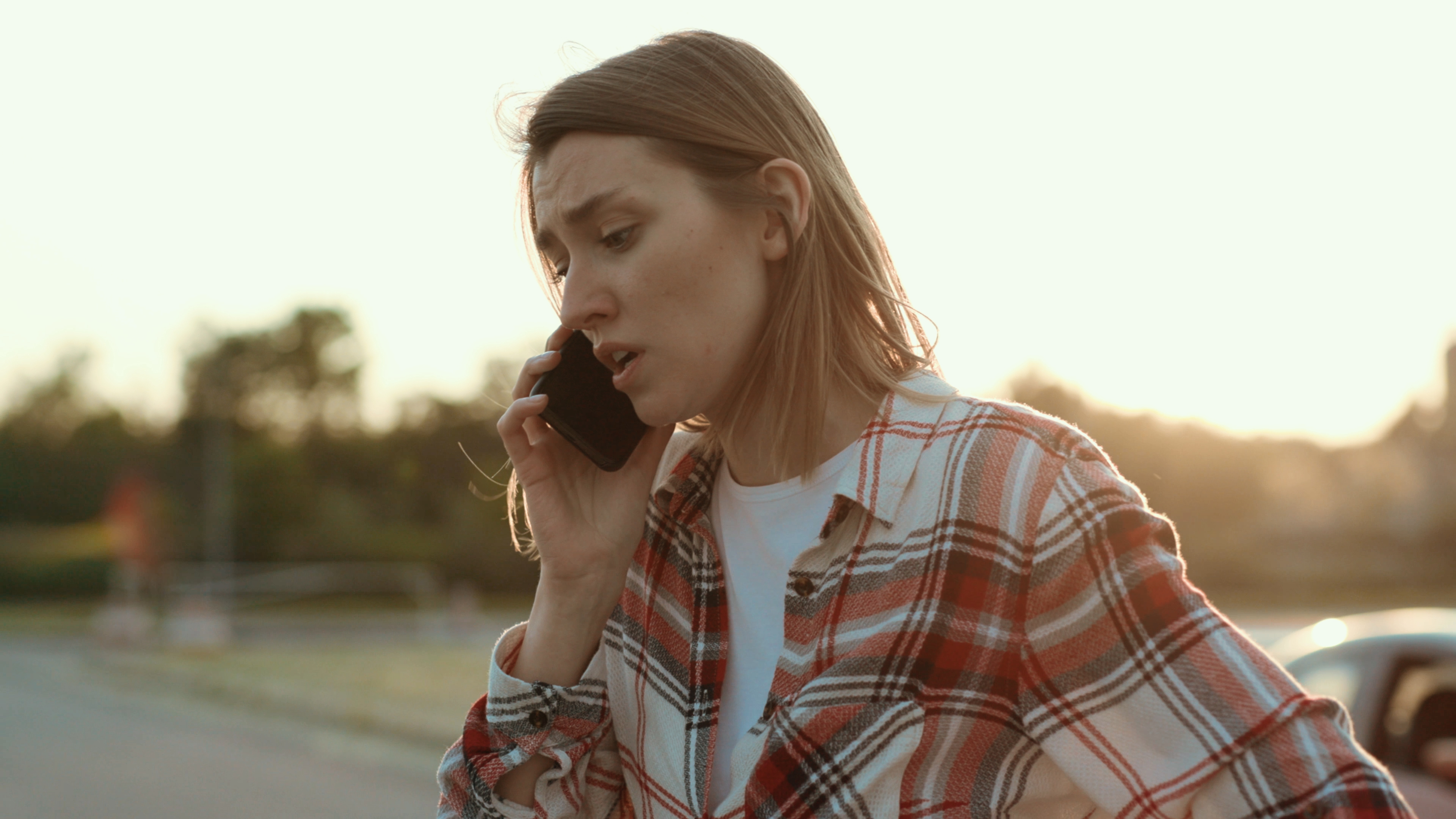 A worried young woman talking on the phone | Source: Shutterstock