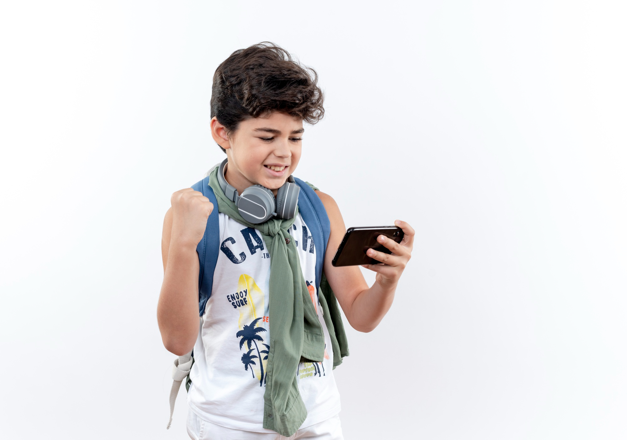 A happy teenage boy celebrating while looking at a phone | Source: Freepik