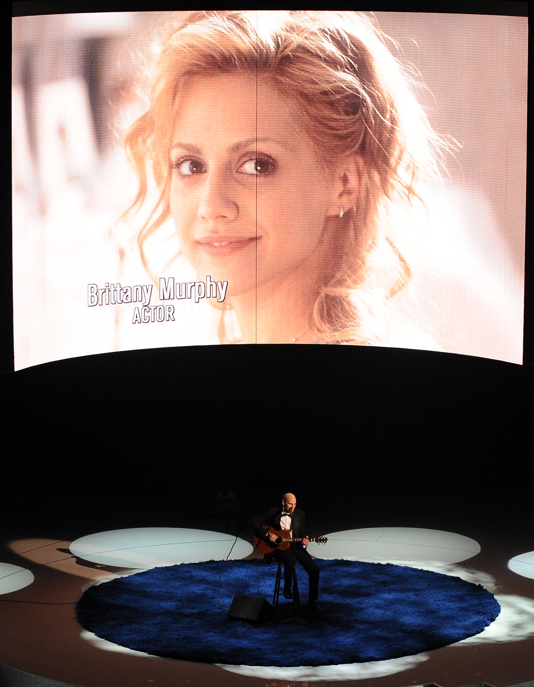 Singer James Taylor pays tribute to deceased actors and singers as an image of Brittany Murphy is projected behind him at the 82nd Academy Awards at the Kodak Theater in Hollywood, California on March 7, 2010. | Source: Getty Images