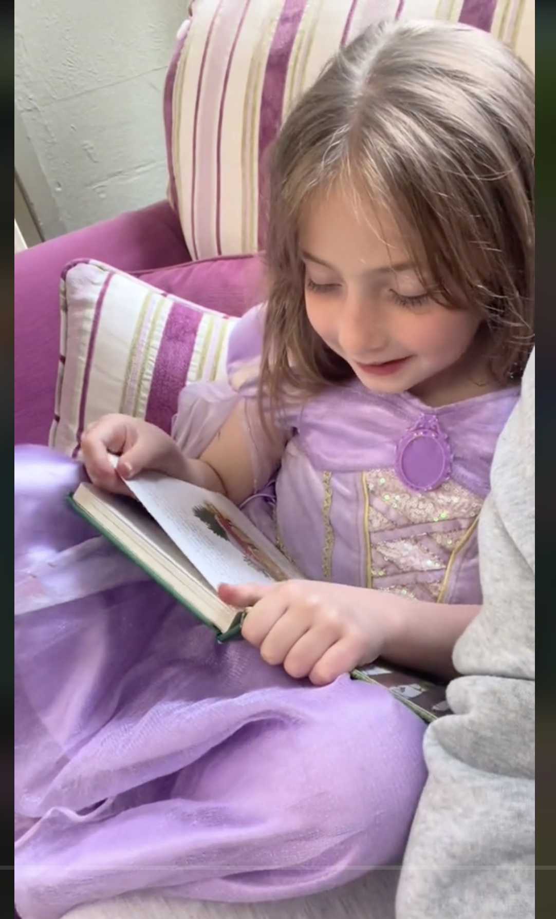 Nicole Austin's daughter reading a book, as seen in a clip dated June 1, 2024 | Source: TikTok/@theaustins_1