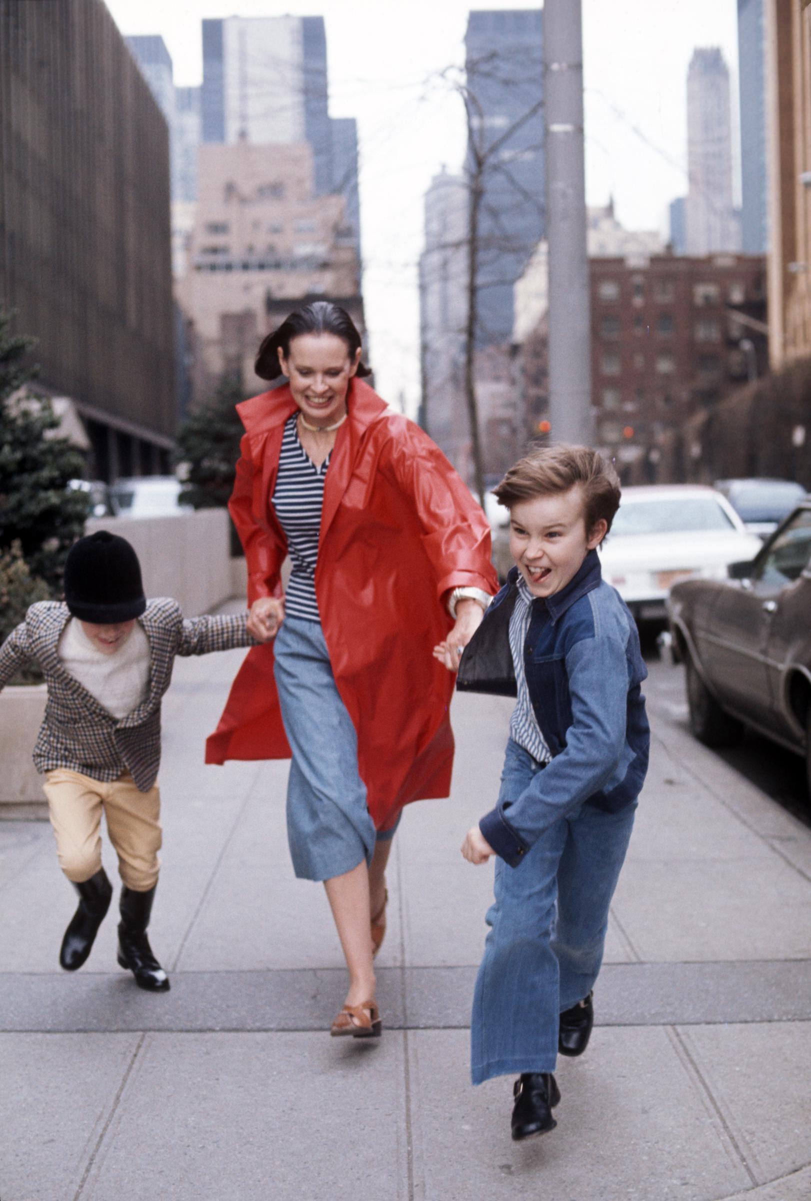 Gloria Vanderbilt runs down a street with her two sons Anderson Cooper and Carter Vanderbilt Cooper in New York circa 1976. | Source: Getty Images