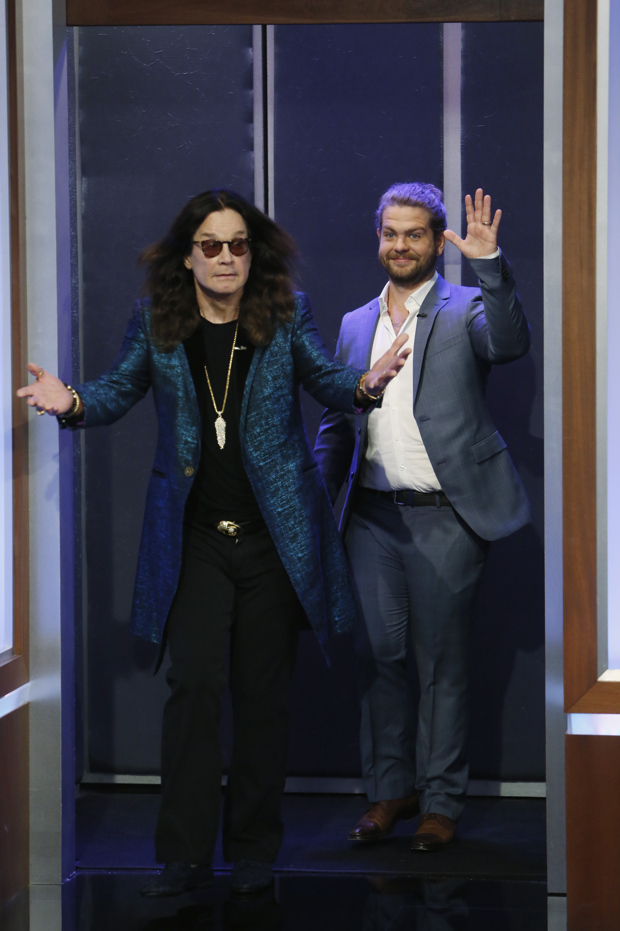 Ozzy Osbourne walks out with arms spread as his son Jack waves to the crowd during their appearance on Jimmy Kimmel Live! in Los Angeles on 11 April 2016.