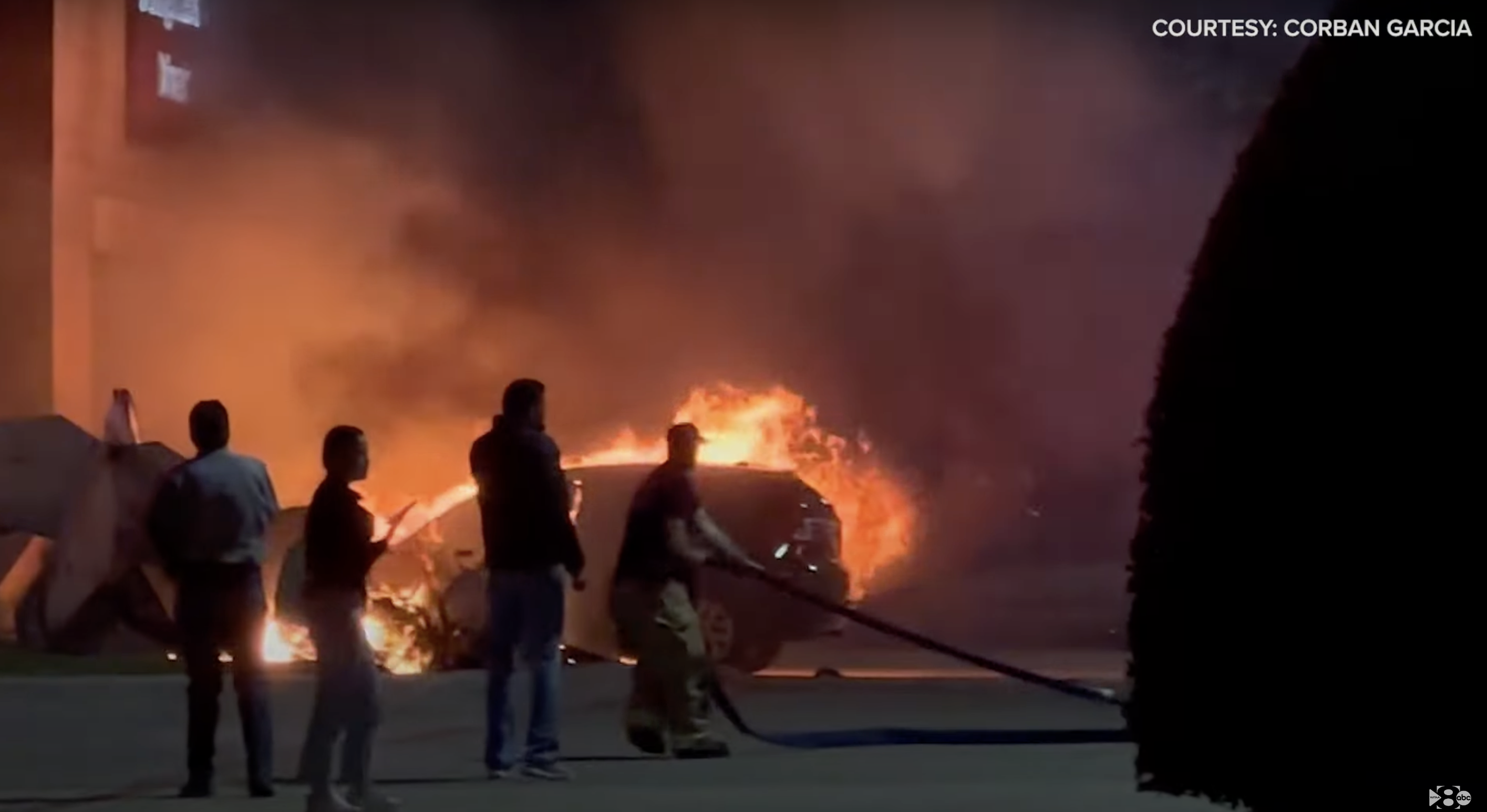 The crash site showing firefighters extinguishing the flames and people running around in fear, as seen in a video dated November 22, 2023 | Source: youtube.com/Wfaa8