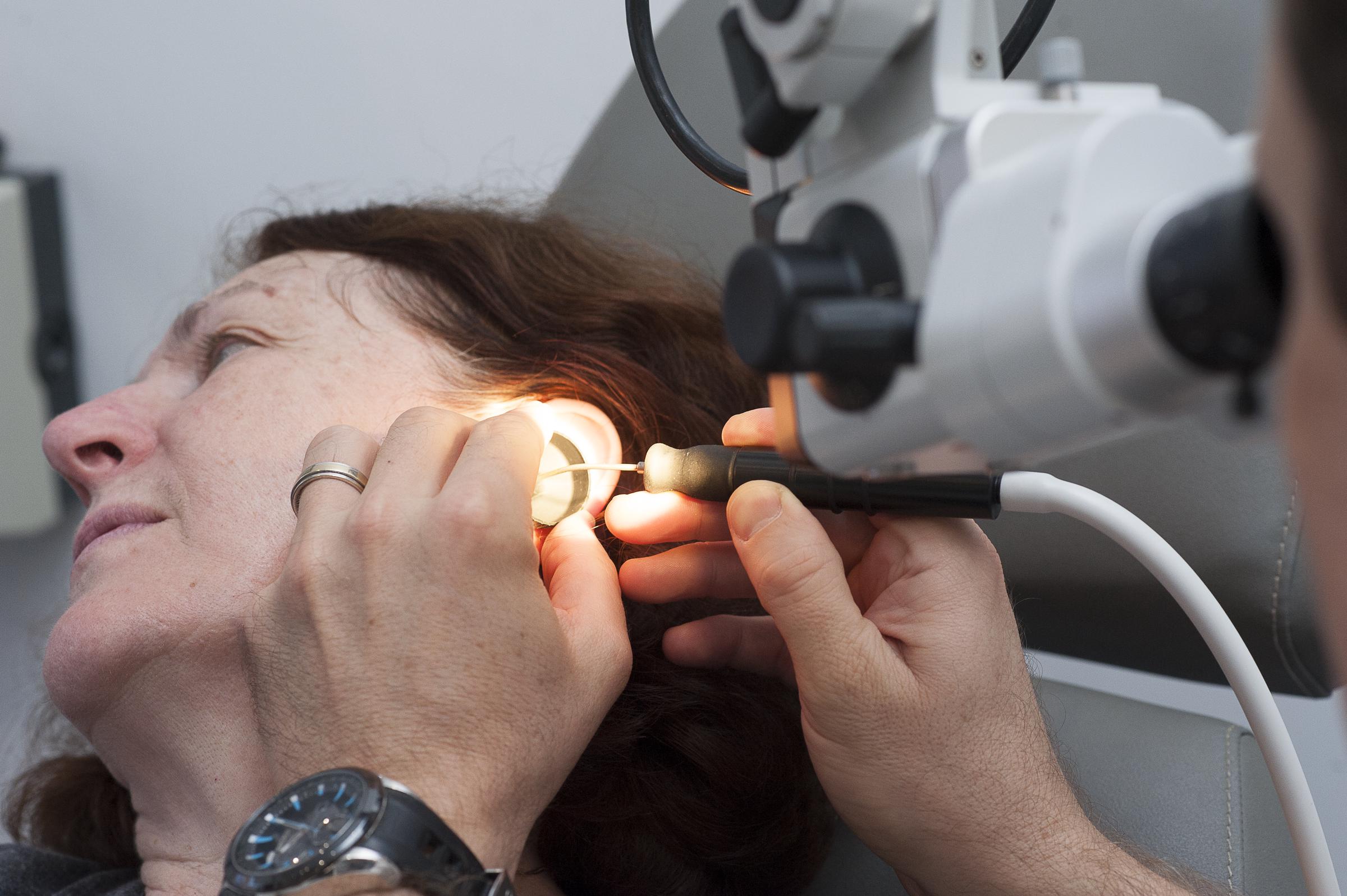 Detailed ear examination performed by an ENT doctor using precision tools and a surgical microscope | Source: Getty Images