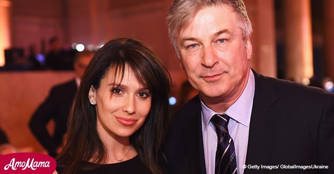 Alec Baldwin is seen gazing lovingly at his wife as she flaunts her baby bump in a floral gown