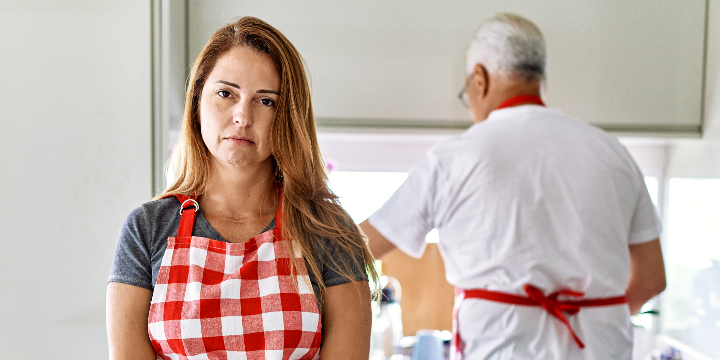 An upset woman in an apron | Source: Shutterstock