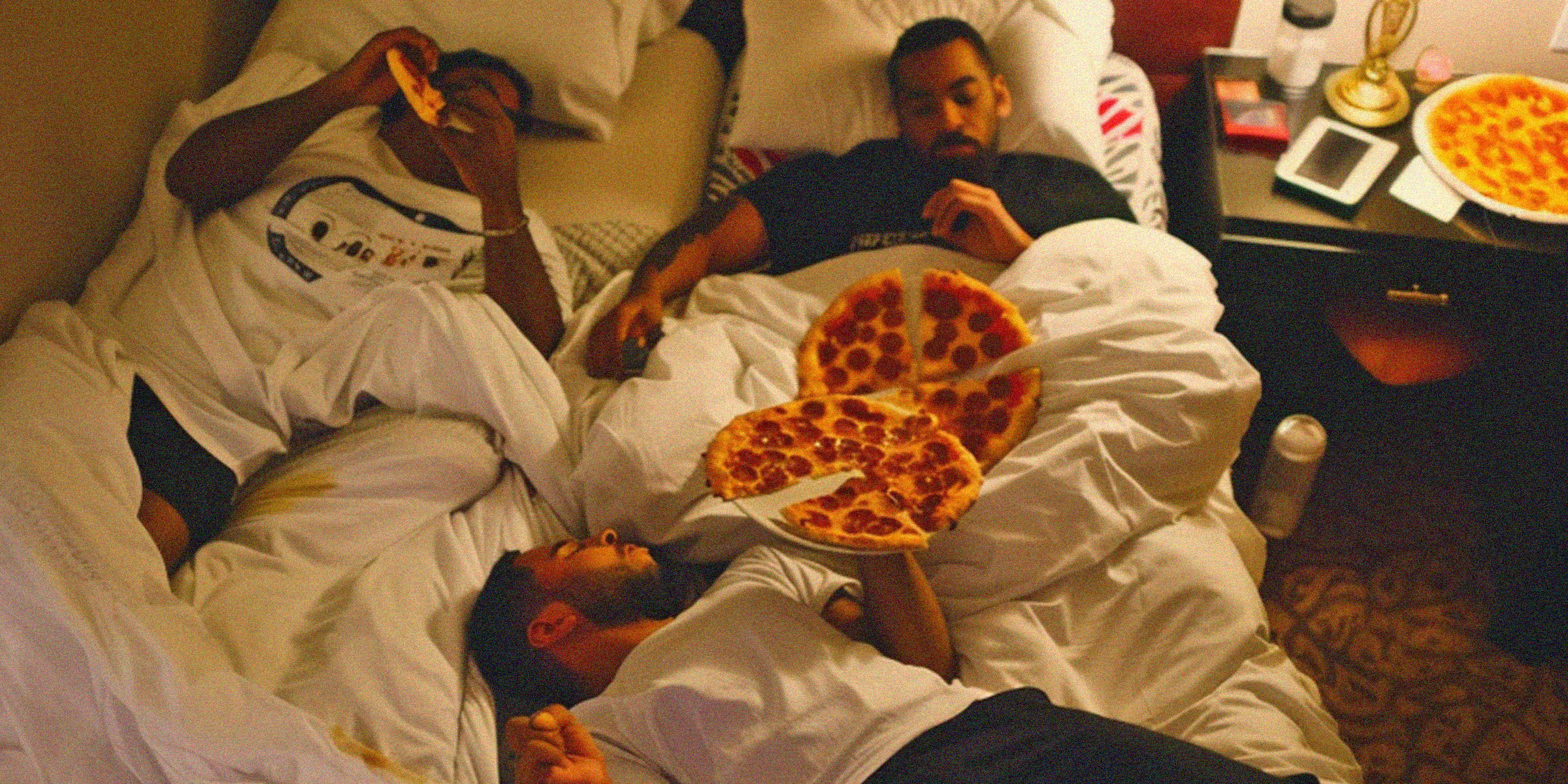 Men enjoying a pizza party | Source: AmoMama
