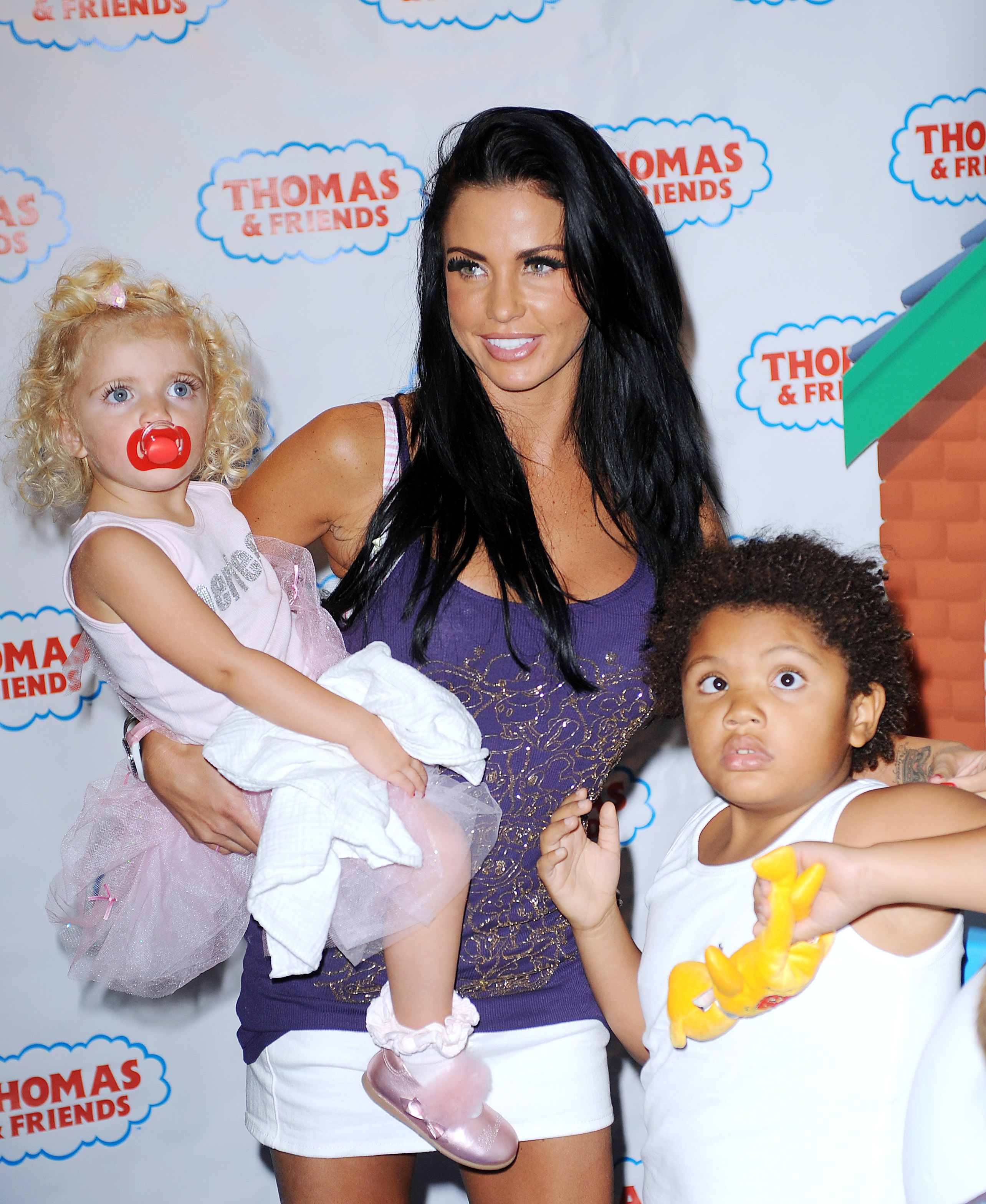 Katie Price stepped out with her children, Princess Andre and Harvey Price, for the London premiere of "Thomas & Friends: Hero of the Rails" on September 26, 2009. Dressed casually in a purple vest and white shorts, Price balanced red carpet duties with mum mode, carrying her  tutu-clad daughter while her son held onto a toy, capturing a rare public family moment during her reality TV heyday.