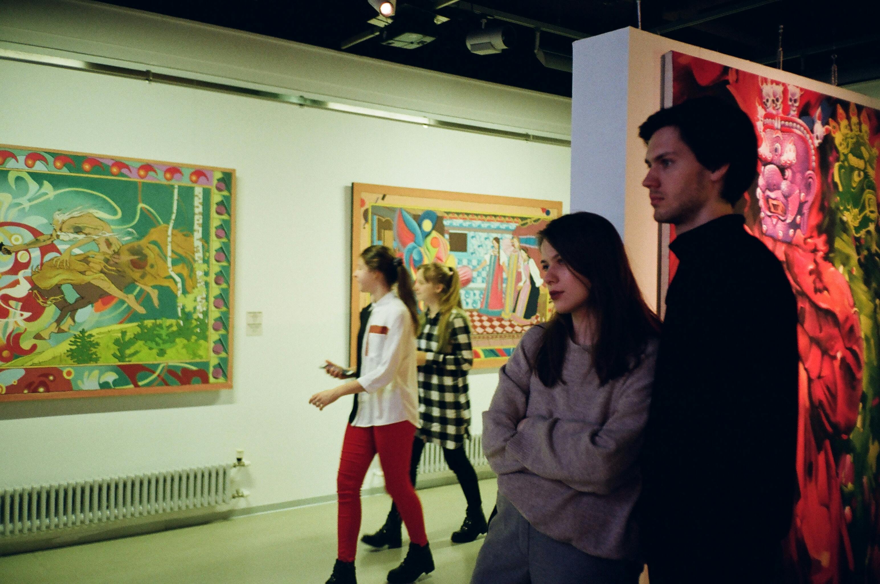 Patrons walk through an art exhibition | Source: Pexels