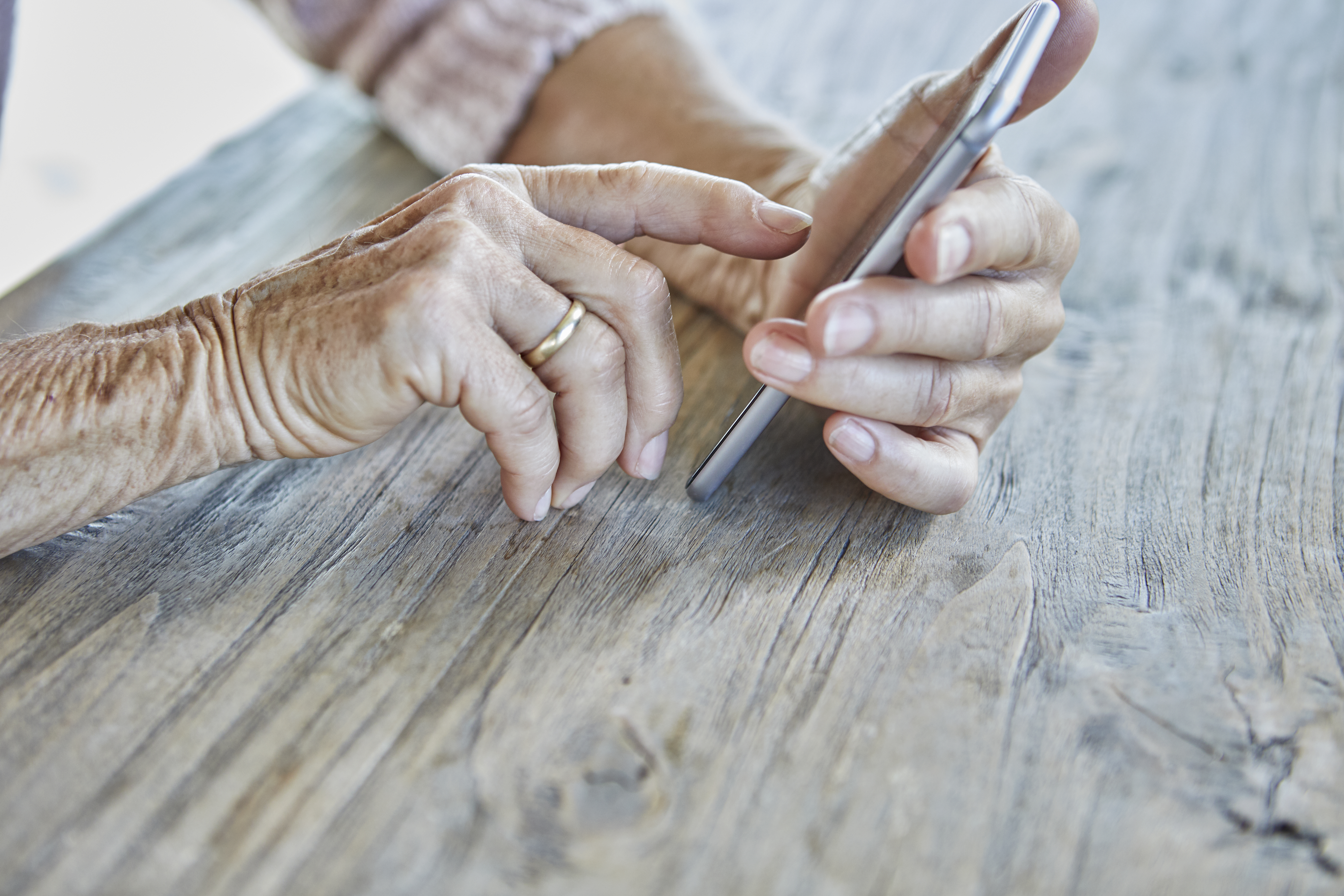 Woman's hands using smartphone, close-up | Source: Getty Images