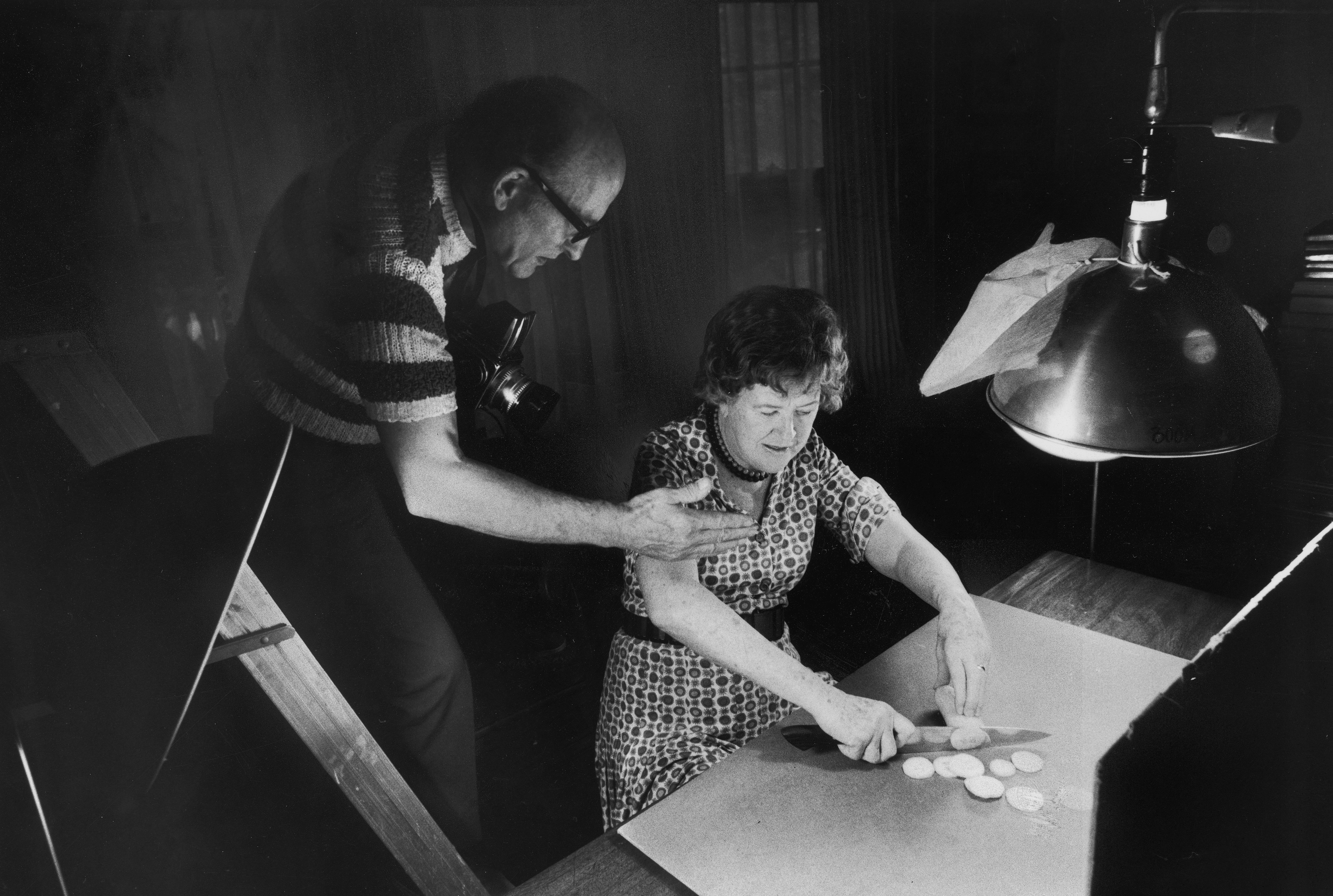 Julia Child chopping squash as her husband, Paul photographs her for an upcoming cookbook. Photo: Getty Images