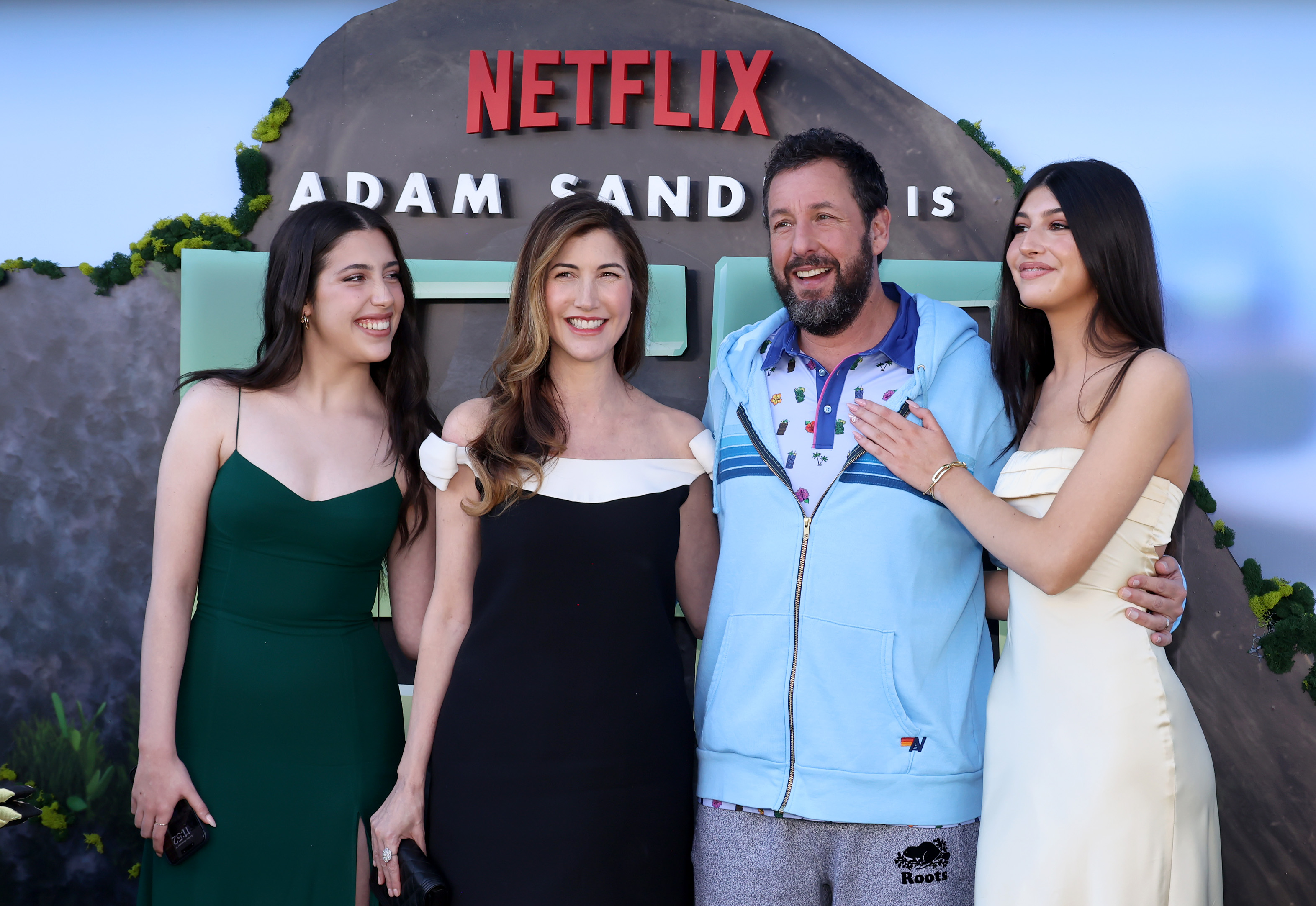 Sadie, Jackie, and Sunny Sandler dazzled in glamorous dresses, bringing all the style to the premiere of Netflix's "Leo" at Regency Village Theatre in Los Angeles, California. Meanwhile Adam kept true to his laid-back charm in sweatpants, a coat, and a polo shirt.