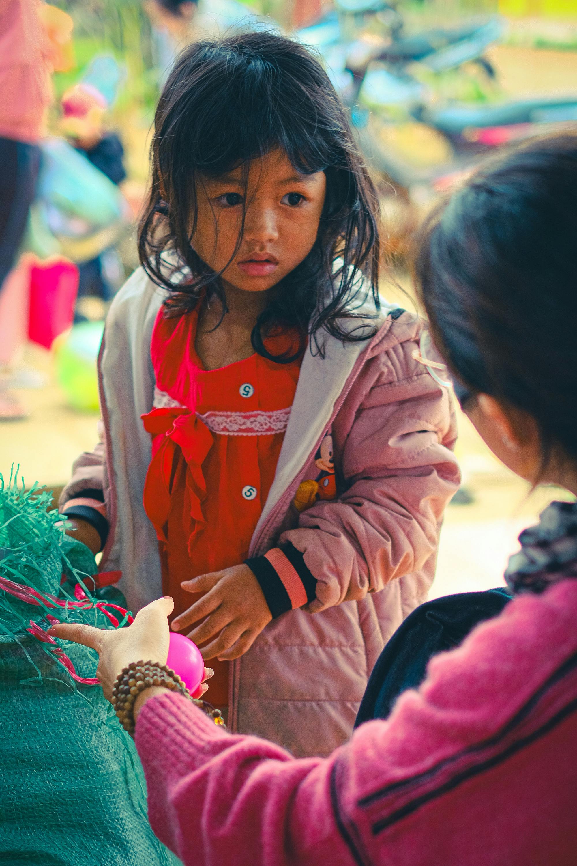 A scared little girl listening as a woman talks to her | Source: Pexels