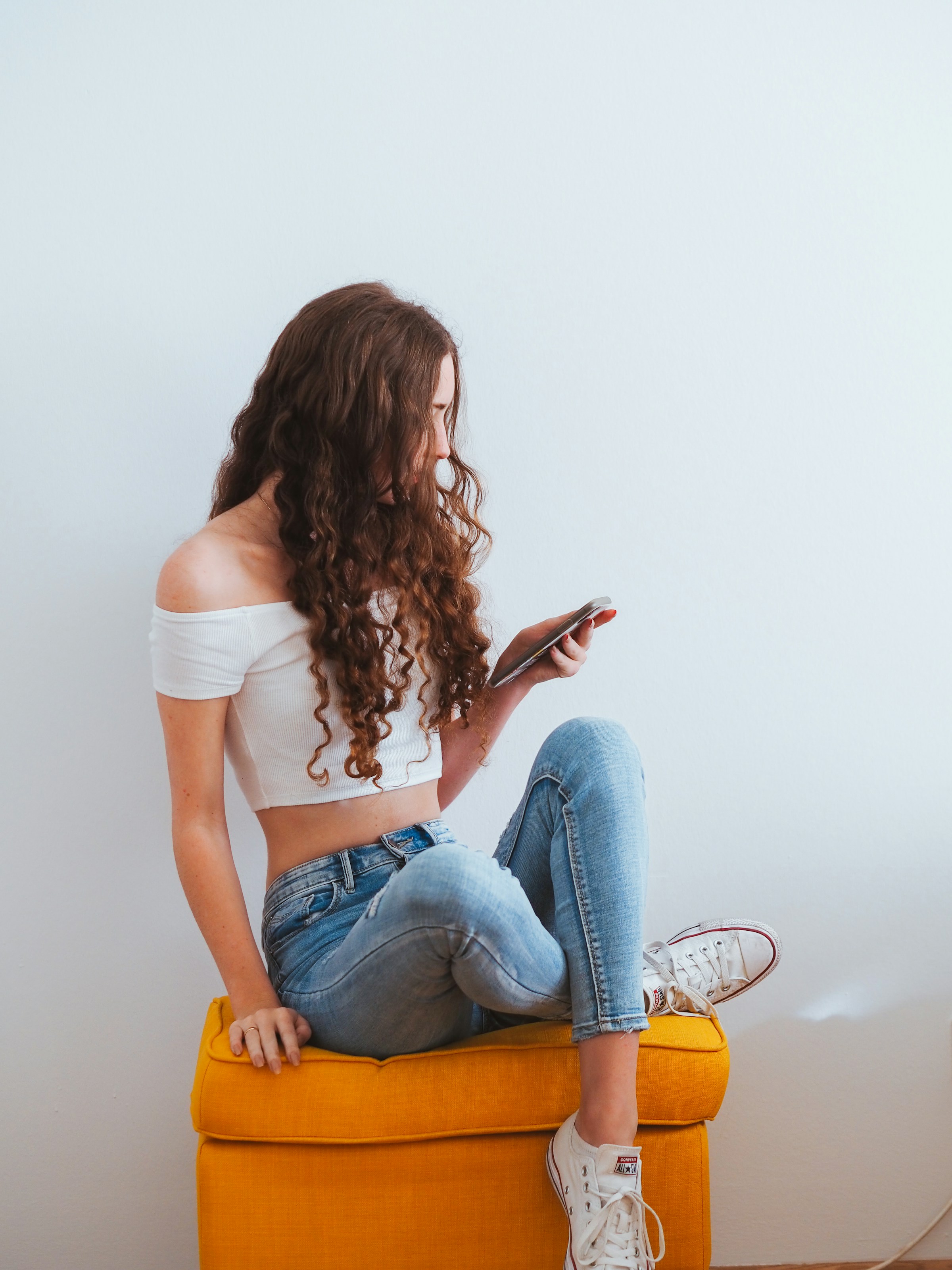 A young woman holding her phone | Source: Unsplash