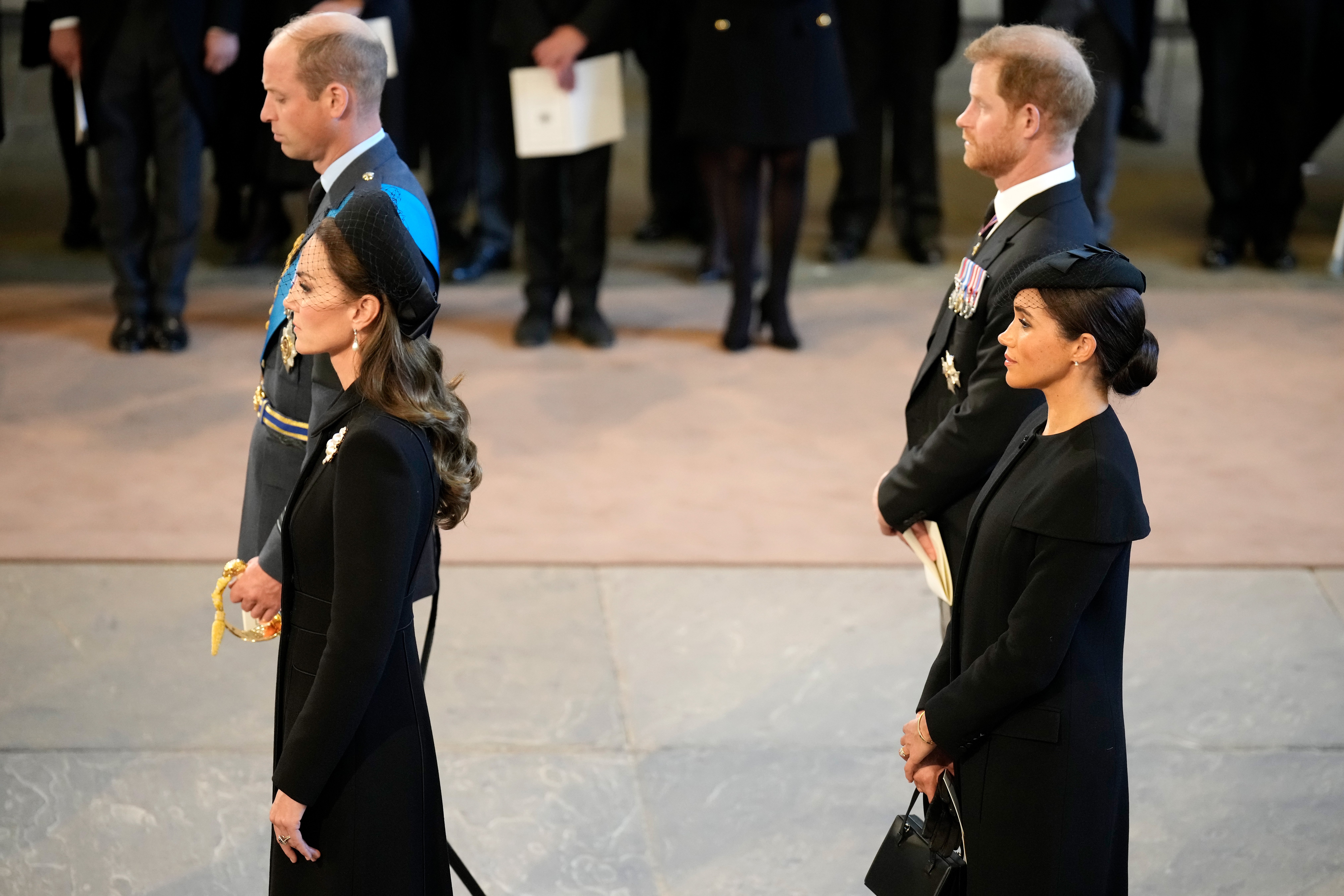 Catherine, Princess of Wales, Prince William, Prince of Wales, Meghan, Duchess of Sussex and Prince Harry, Duke of Sussex pay their respects in The Palace of Westminster after the procession for the Lying-in State of Queen Elizabeth II on September 14, 2022 in London, England | Source: Getty Images 