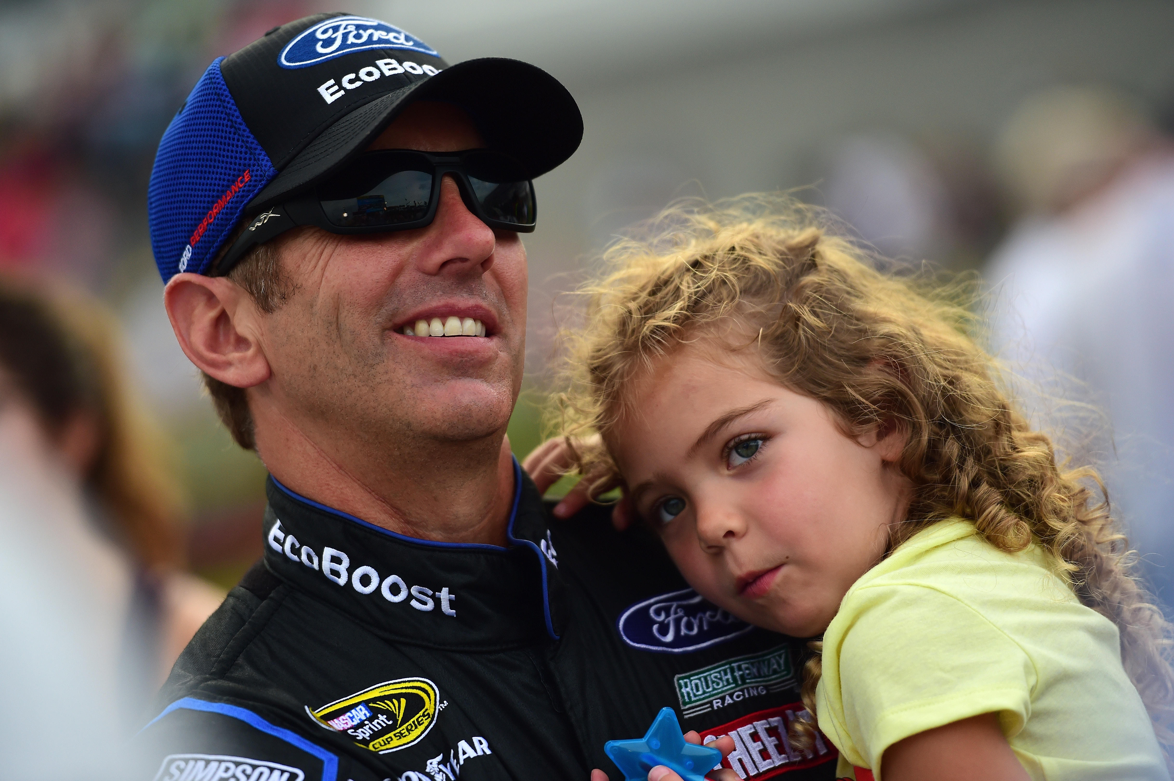 Greg Biffle holds his daughter Emma on the grid during the NASCAR Sprint Cup Series Coke Zero 400 at Daytona International Speedway in Florida  on July 2, 2016. | Source: Getty Images