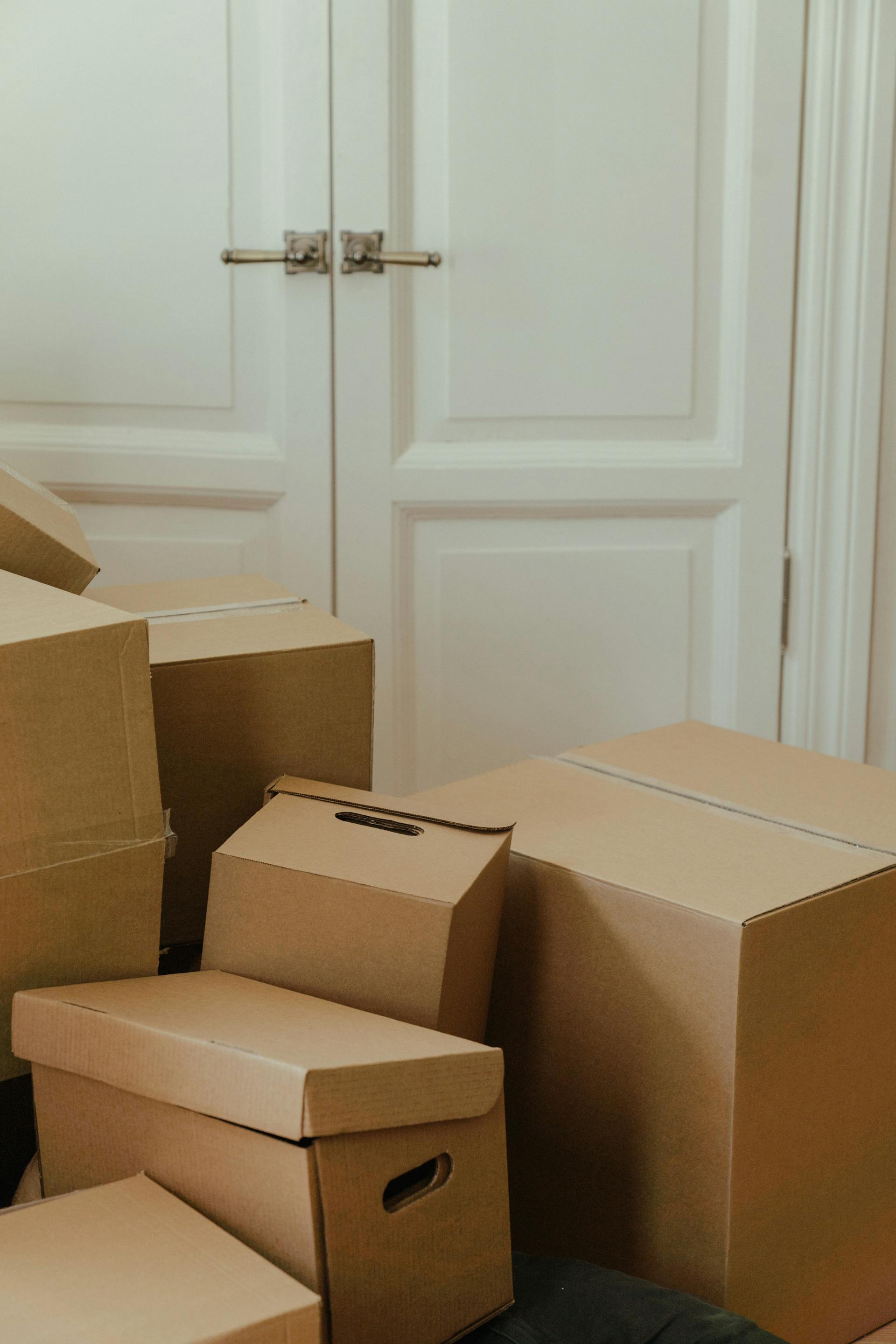 Brown cardboard boxes near the door | Source: Pexels