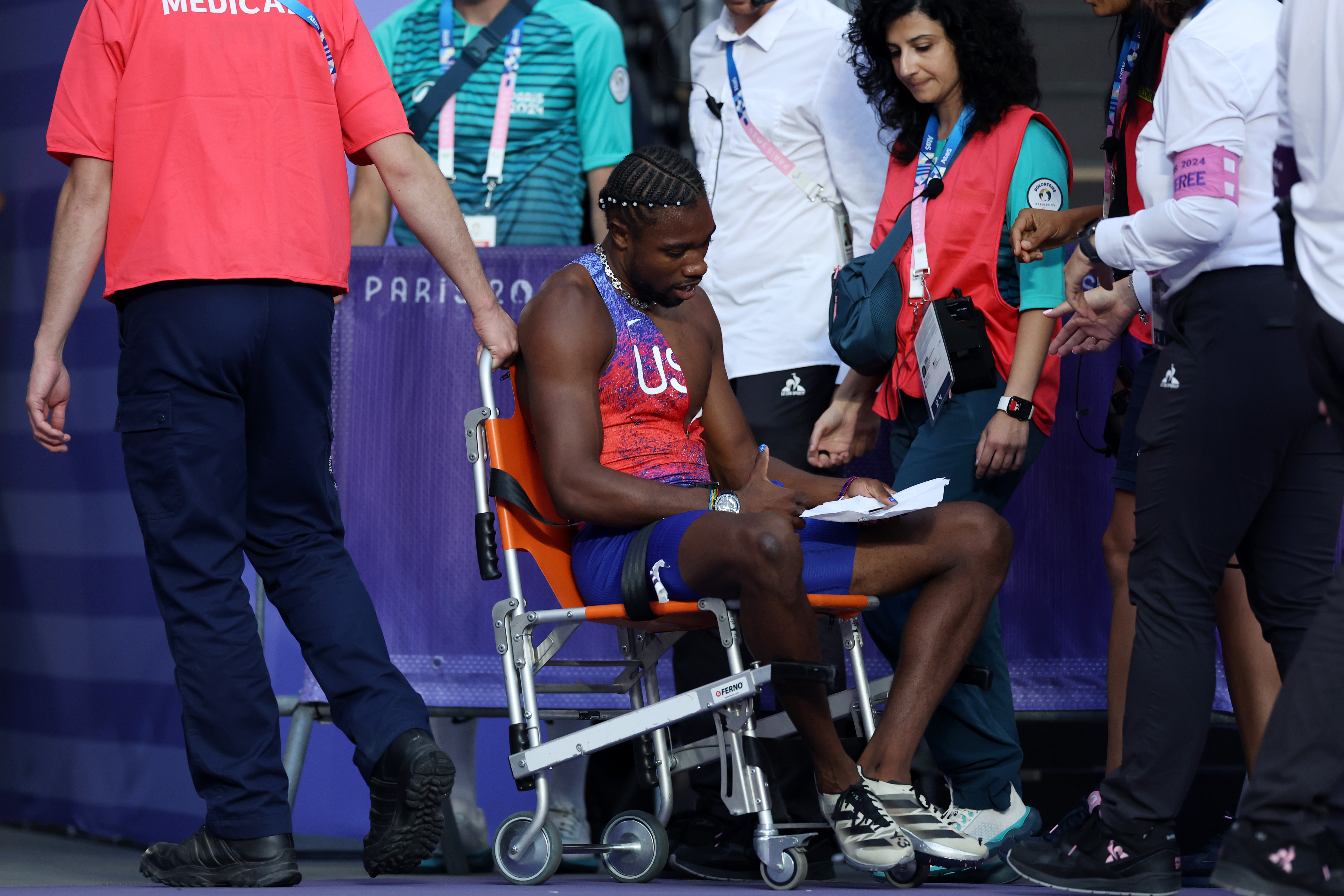 Noah Lyles of Team U.S. in a wheelchair after competing in the Men's 200m Final at the Paris Olympic Games on August 8, 2024 | Source: Getty Images