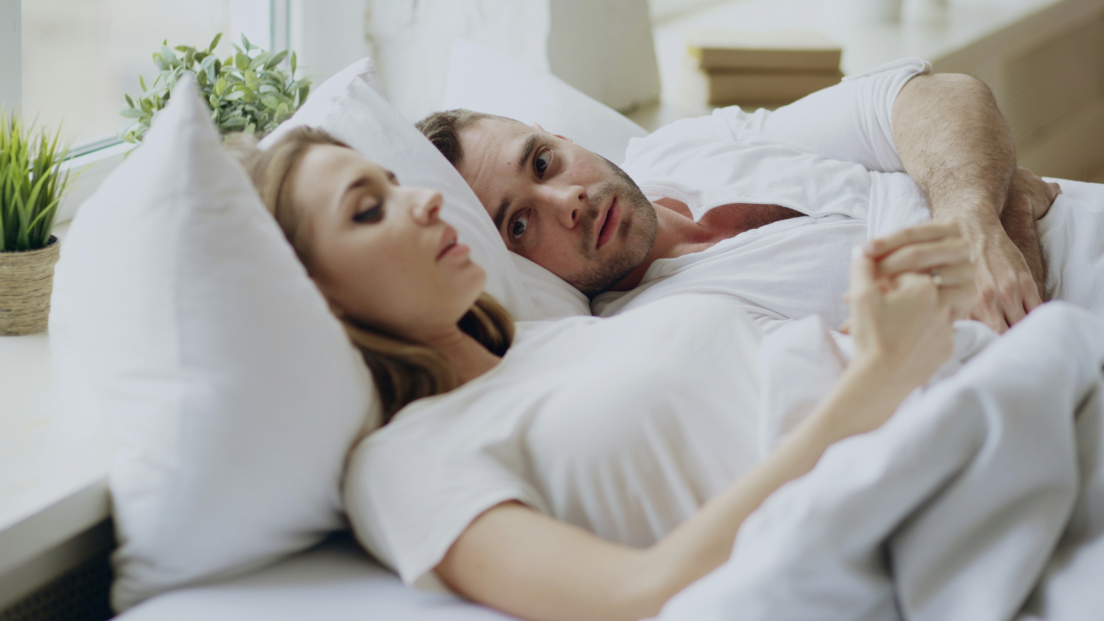 Couple lying in bed | Source: Unsplash