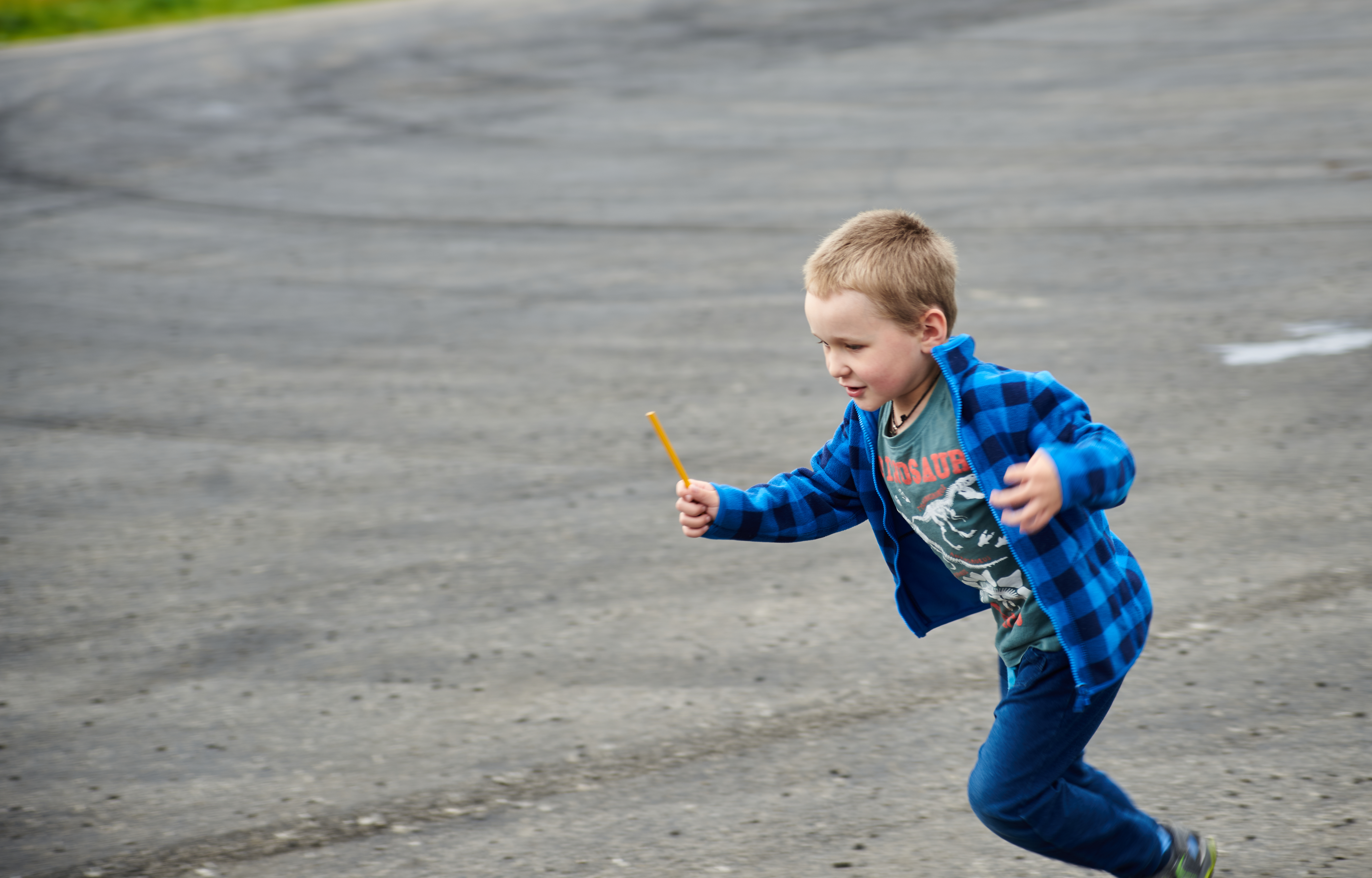 A little boy running on the road | Source: Shutterstock