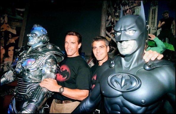 The stars of the film "Batman & Robin," actors Arnold Schwarzenegger (L) and George Clooney (R) pose with their costumes Mr. Freeze and Batman 06 June at Planet Hollywood in Beverly Hills  | Source: Getty Images