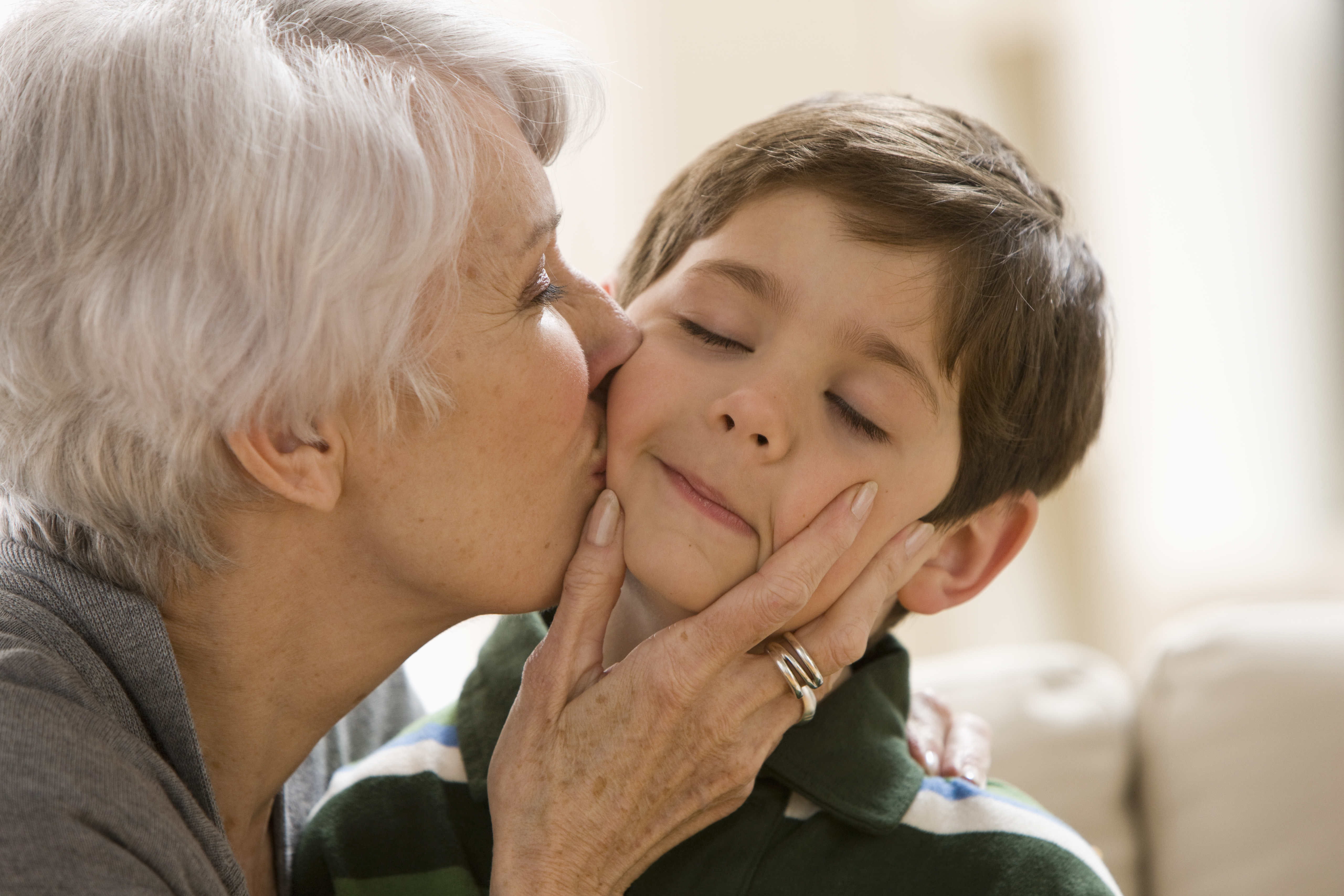 A grandmother kissing her grandson on the cheek | Source: Getty Images