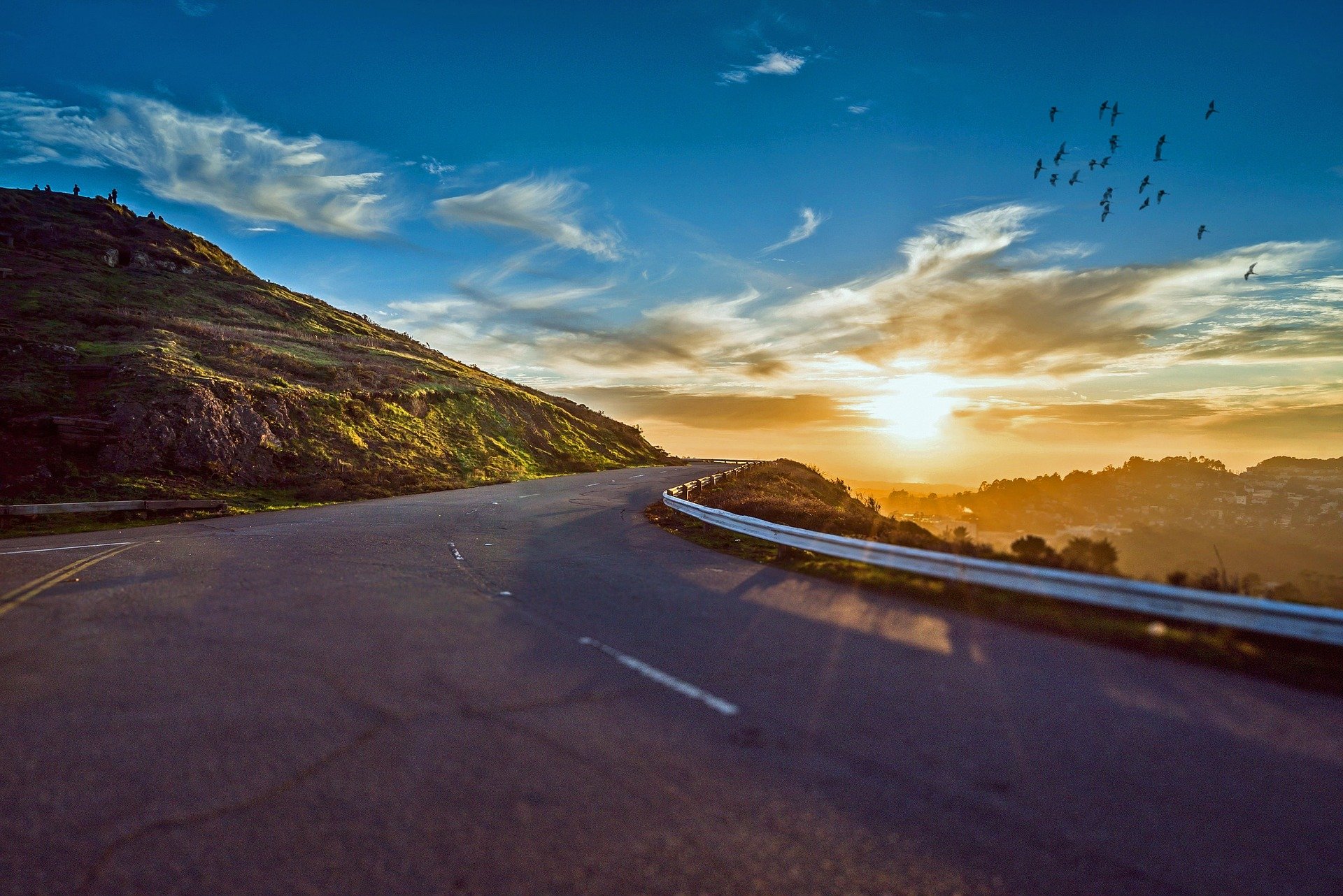 Picture of a winding road taken at sunrise. | Source: Pixabay. 