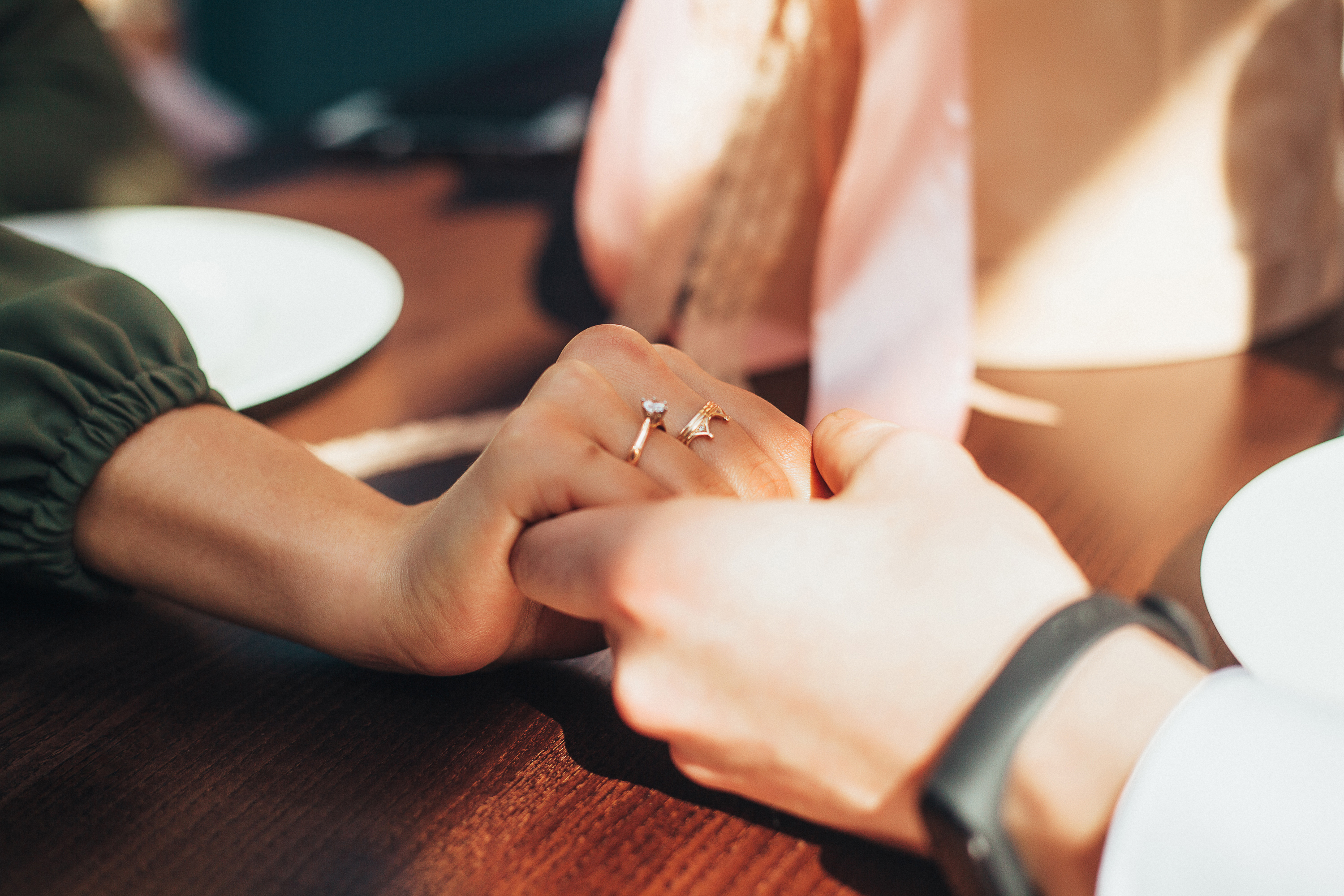 A couple holding hands across a table | Source: Shutterstock