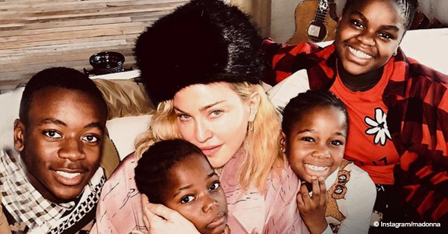 Madonna cuddles up next to her Malawi children in Christmas photo 