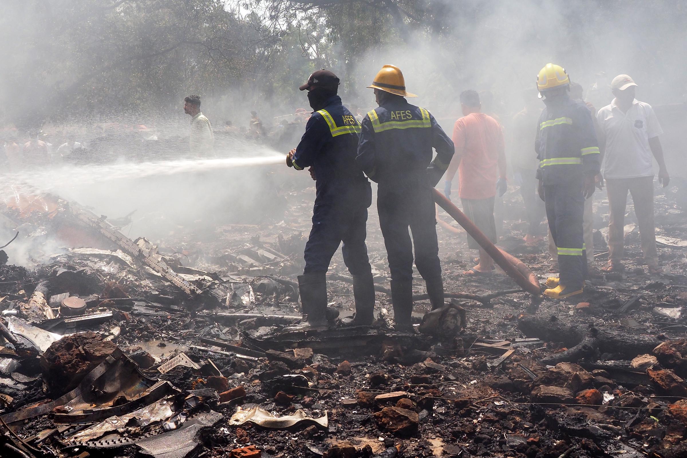 Firefighters work at the site where Air India flight 171 crashed in a residential area near the airport in Ahmedabad on June 12, 2025 | Source: Getty Images