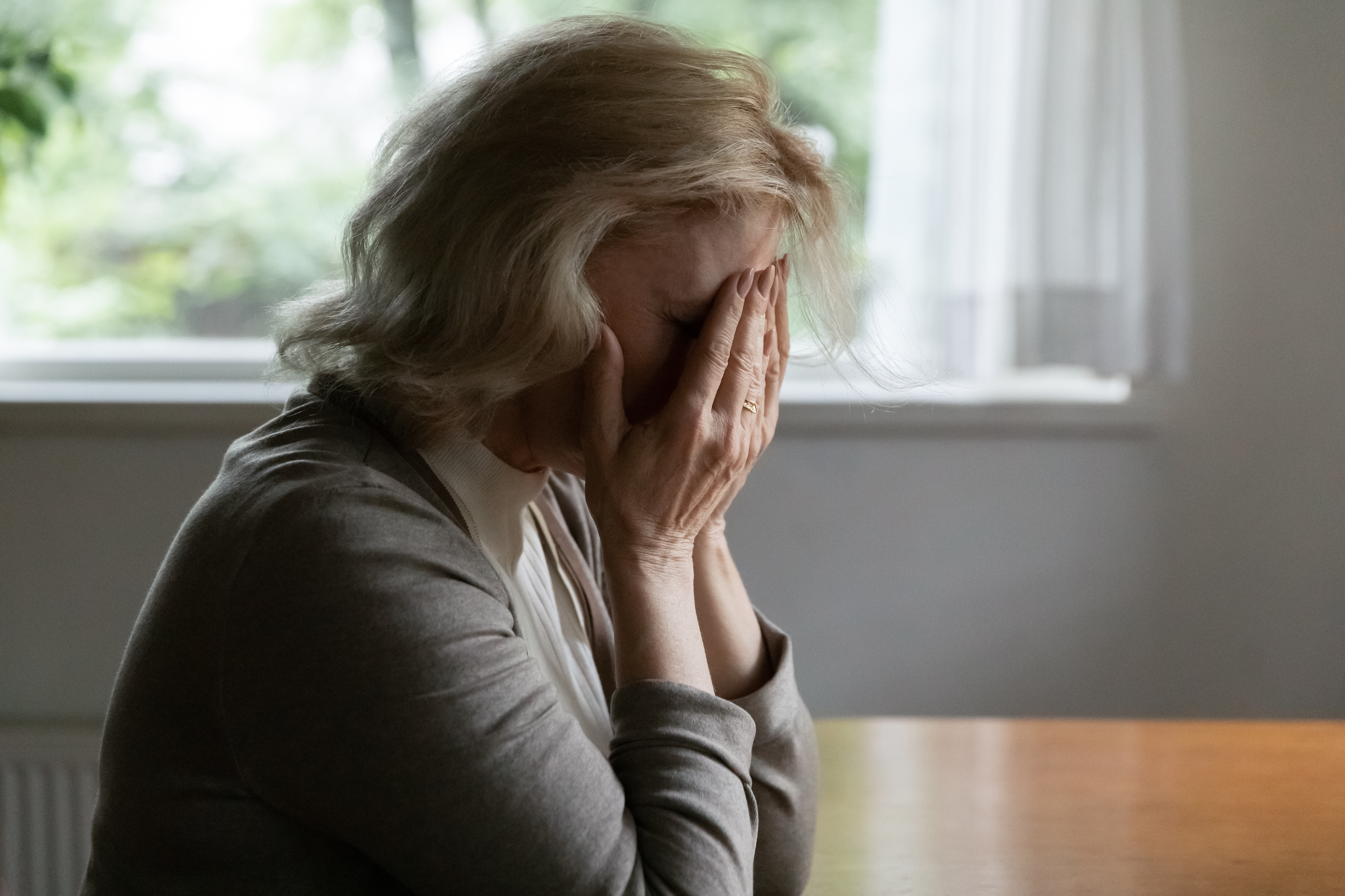 An elderly woman looking sad | Source: Shutterstock