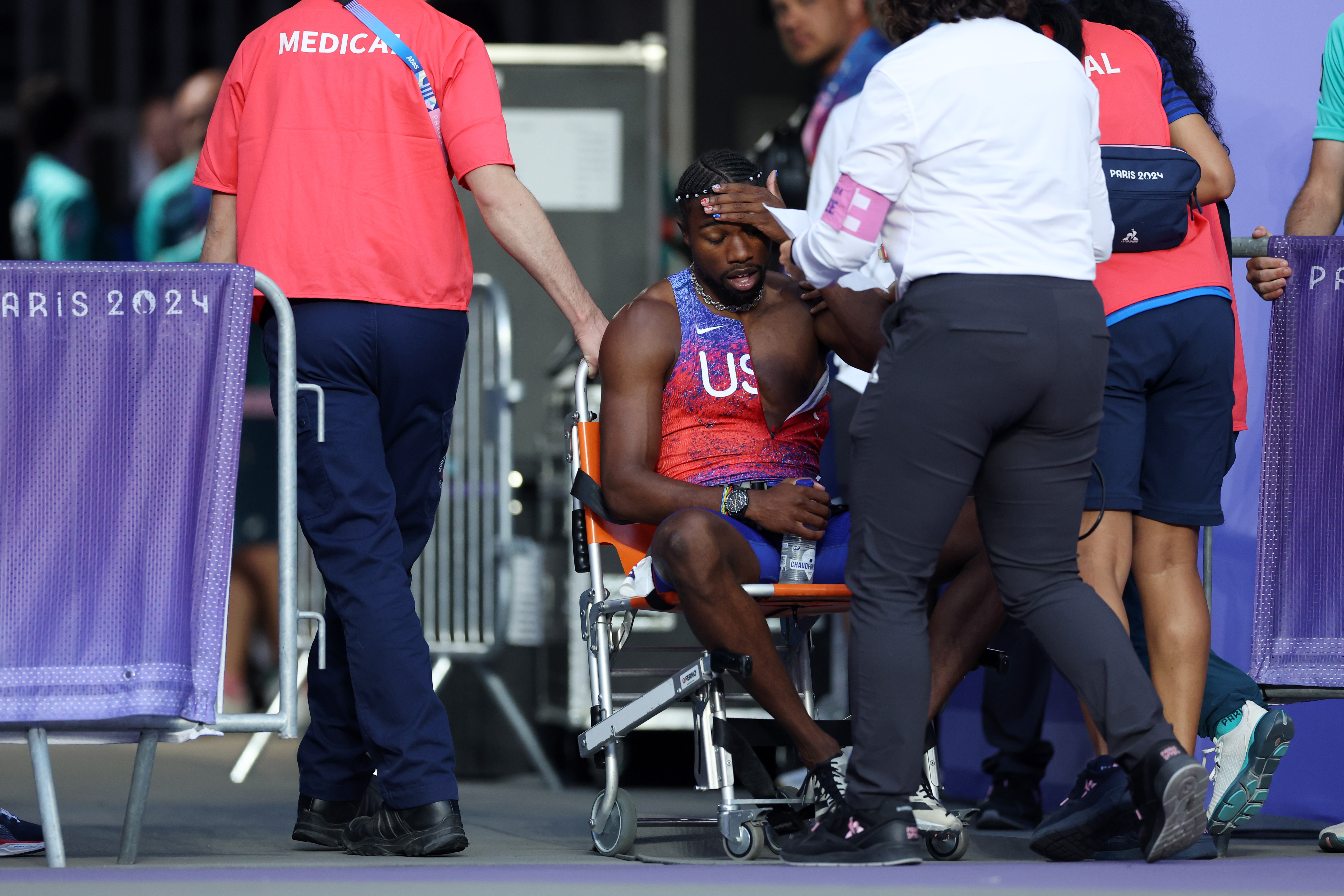 Noah Lyles of the US being taken off from the track with a wheelchair after competing in the Men's 200m Final during the Paris 2024 Summer Olympic Games on August 8, 2024, in Paris, France | Source: Getty Images