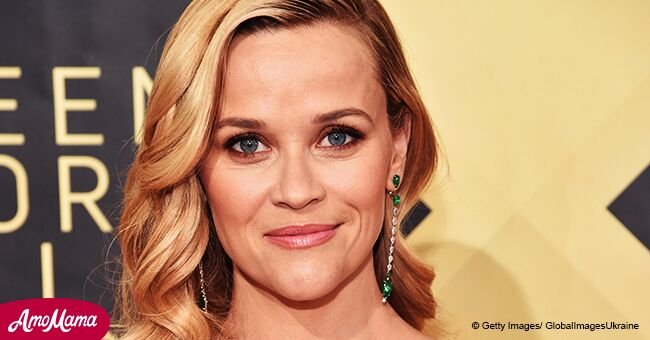 Reese Witherspoon sports a pink sweater and skintight jeans, revealing her youthfulness at 42