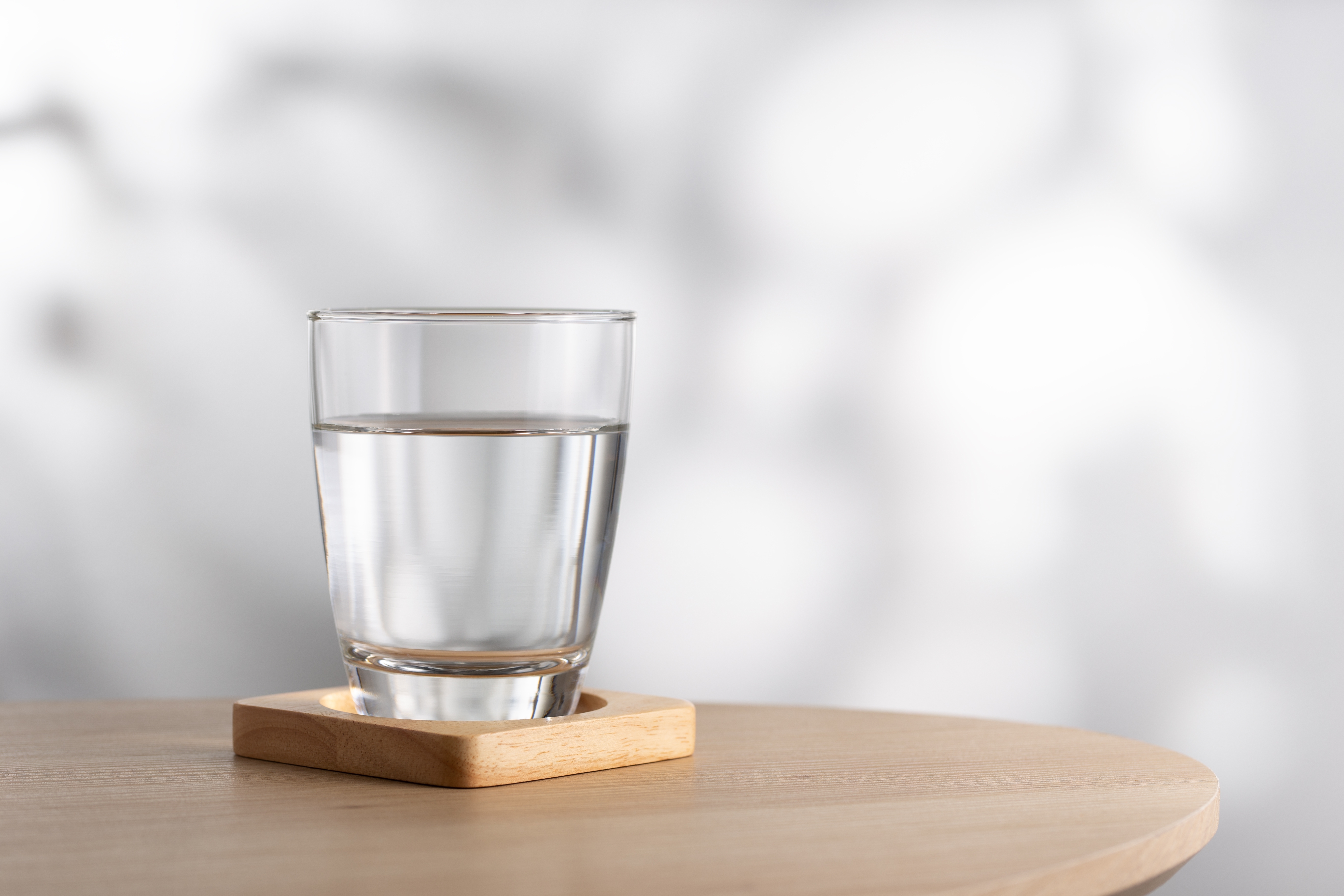A glass of water on a wooden table | Source: Shutterstock