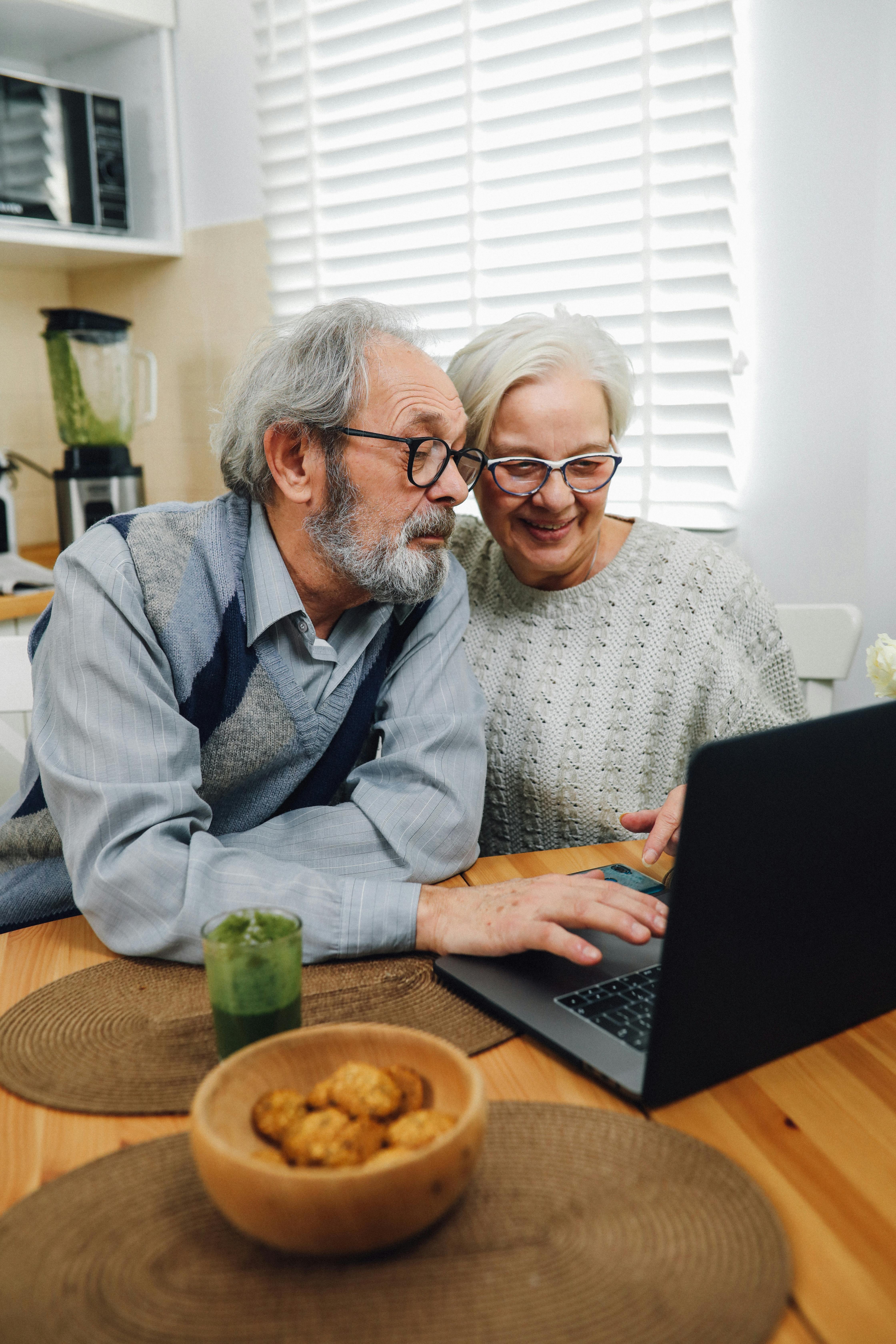 An elderly couple using a laptop together | Source: Pexels