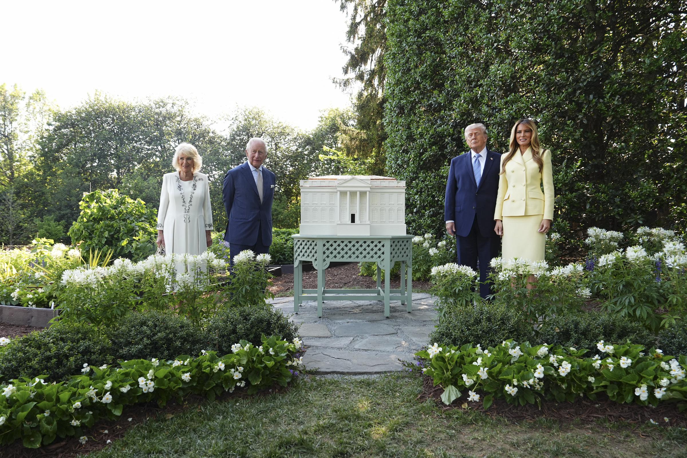 U.S. President Donald Trump, First Lady Melania Trump, King Charles III, and Queen Camilla were photographed standing on the White House South Lawn beside a scale model of a proposed ballroom. The carefully composed scene blended architectural presentation with diplomatic ceremony, as the four figures paused during their tour to mark the opening day of the state visit celebrating the United States' 250th anniversary of independence.
