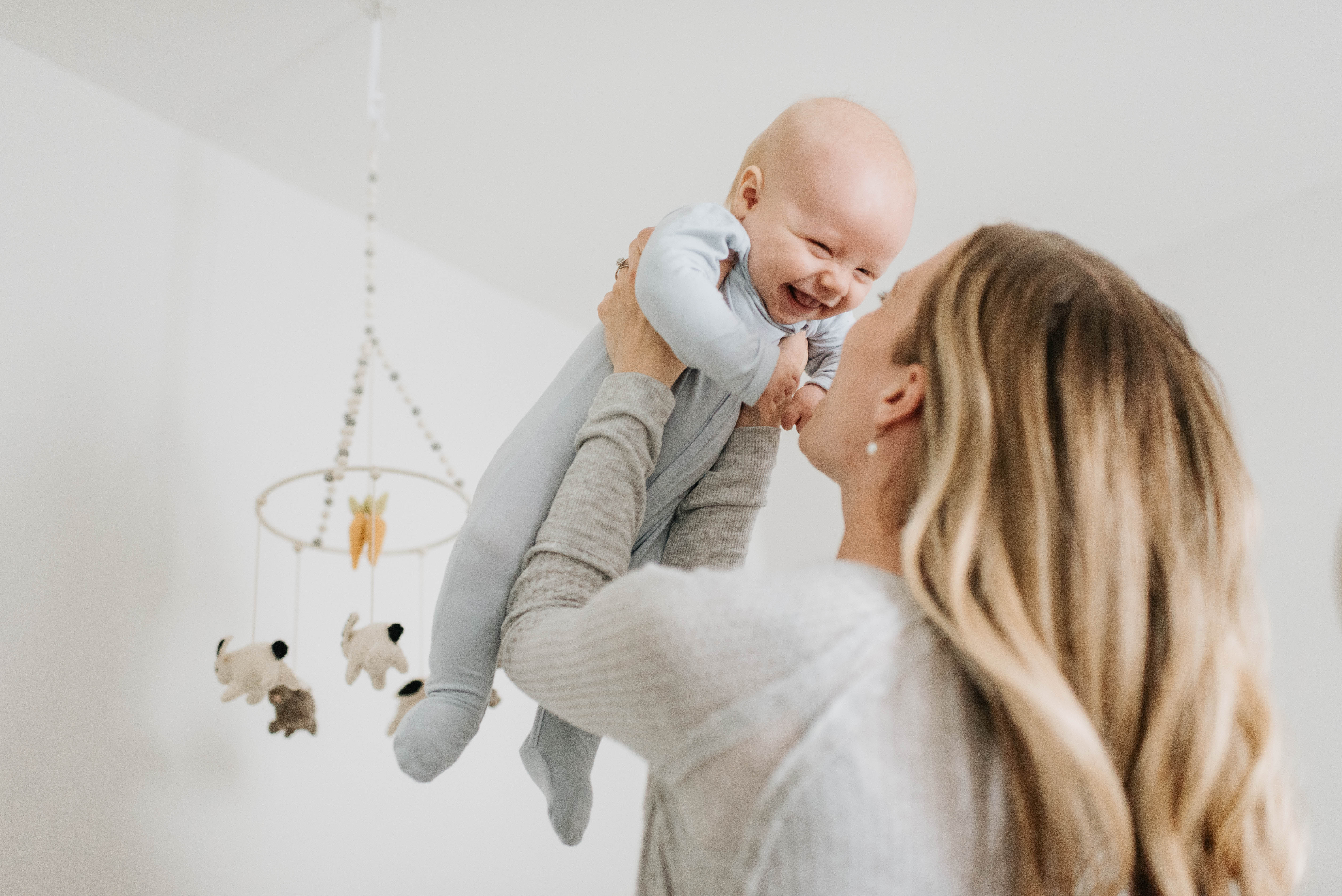 A mother is pictured throwing her baby in the air | Source: Getty Images