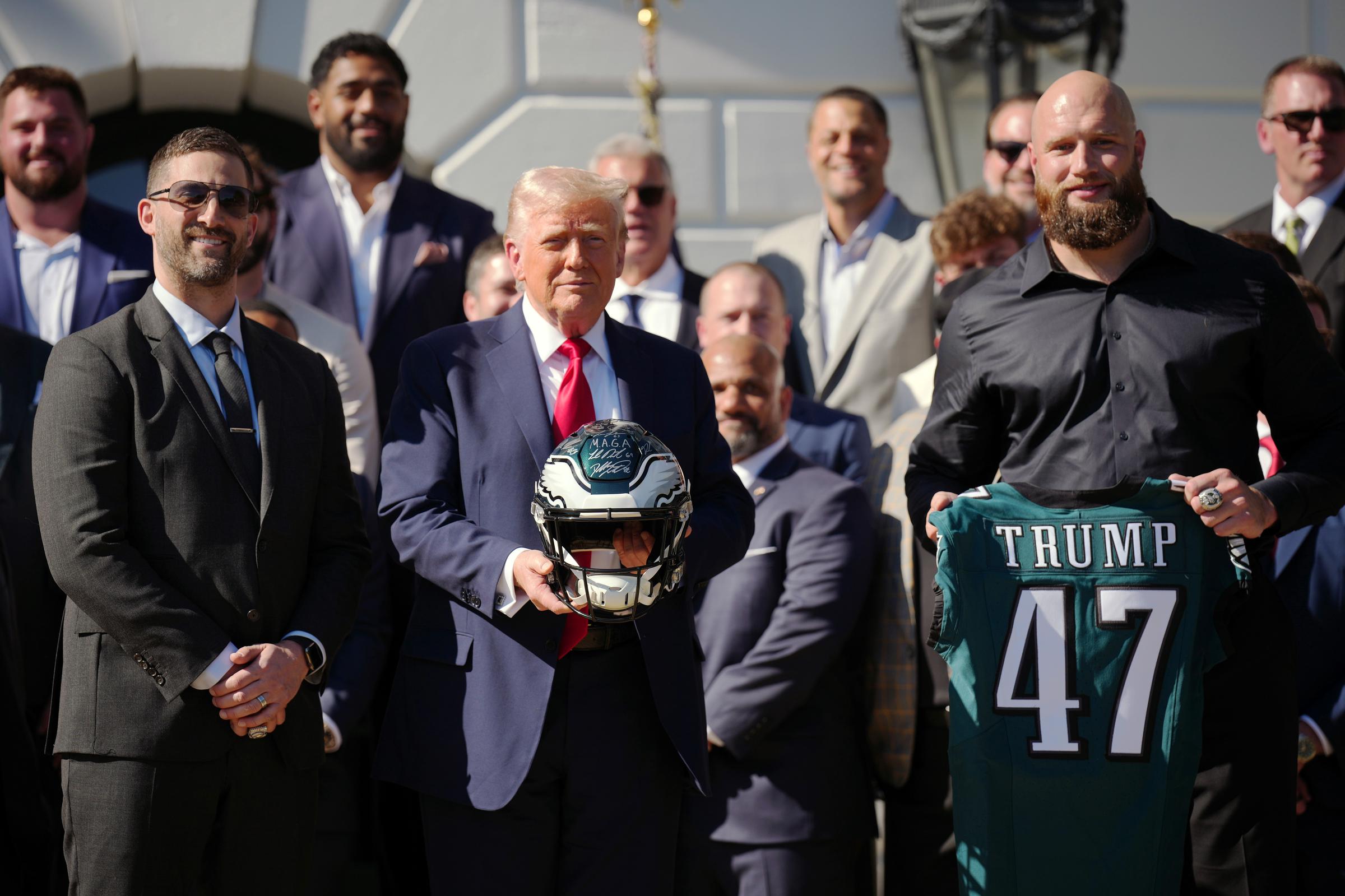 U.S. President Donald Trump (C) poses with Philadelphia Eagles head coach Nick Sirianni and offensive tackle Lane Johnson at an event welcoming the 2025 Super Bowl Champion Philadelphia Eagles on the South Lawn of the White House on April 28, 2025, in Washington, D.C. | Source: Getty Images