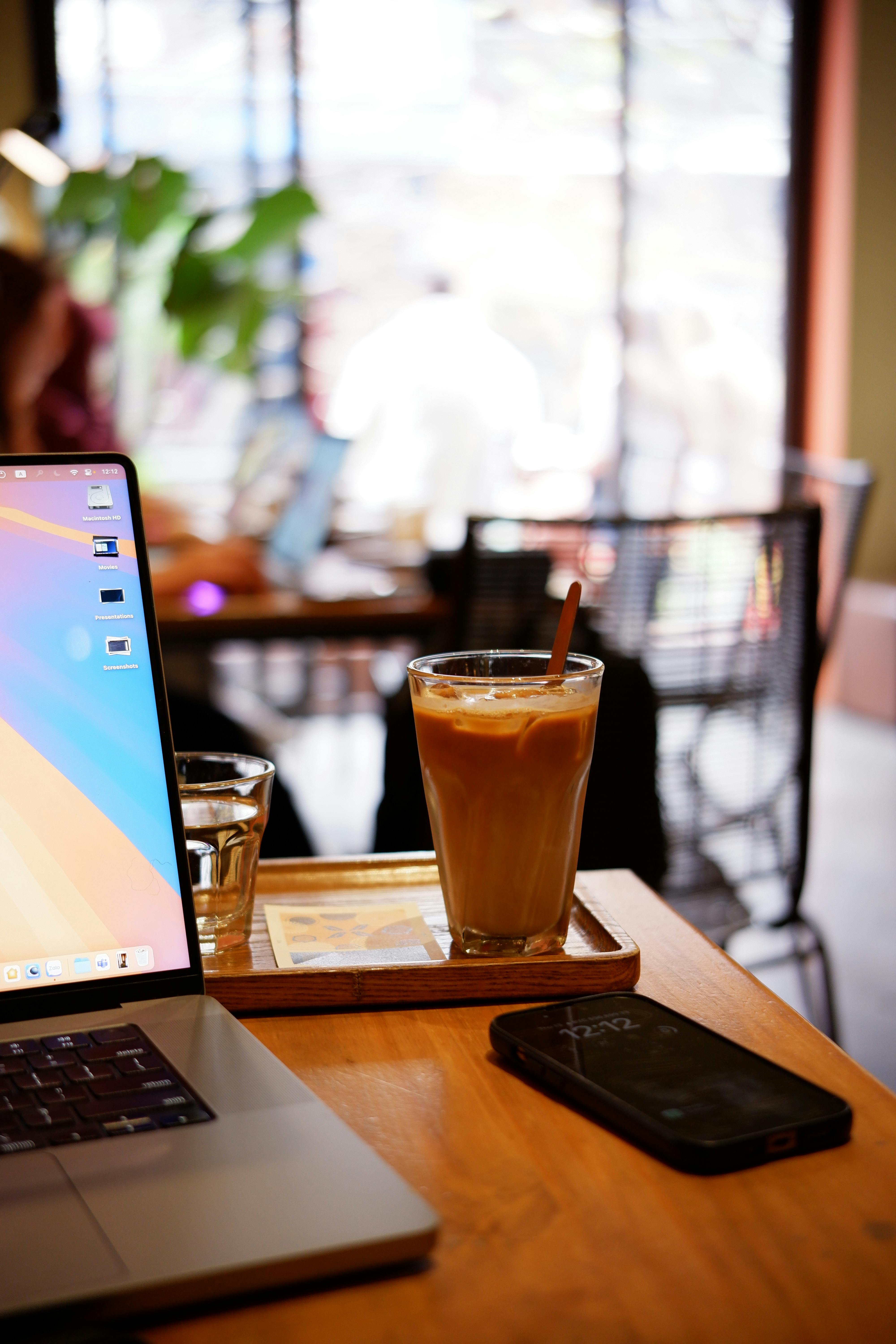 Work set up at a coffee shop | Source: Pexels