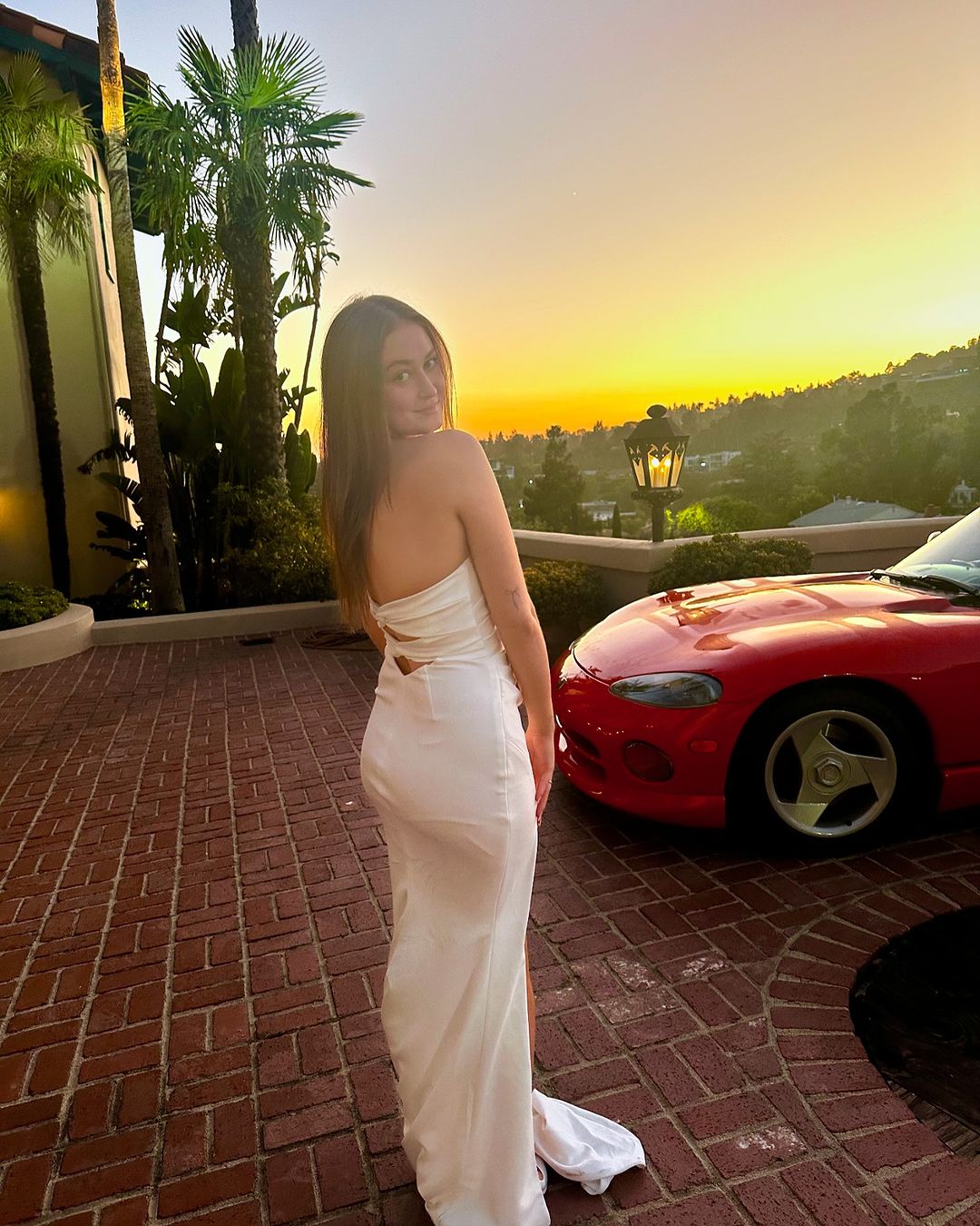 Karsen Liotta posing in front of a red car posted on October 28, 2024 | Source: Instagram/karsen_liotta