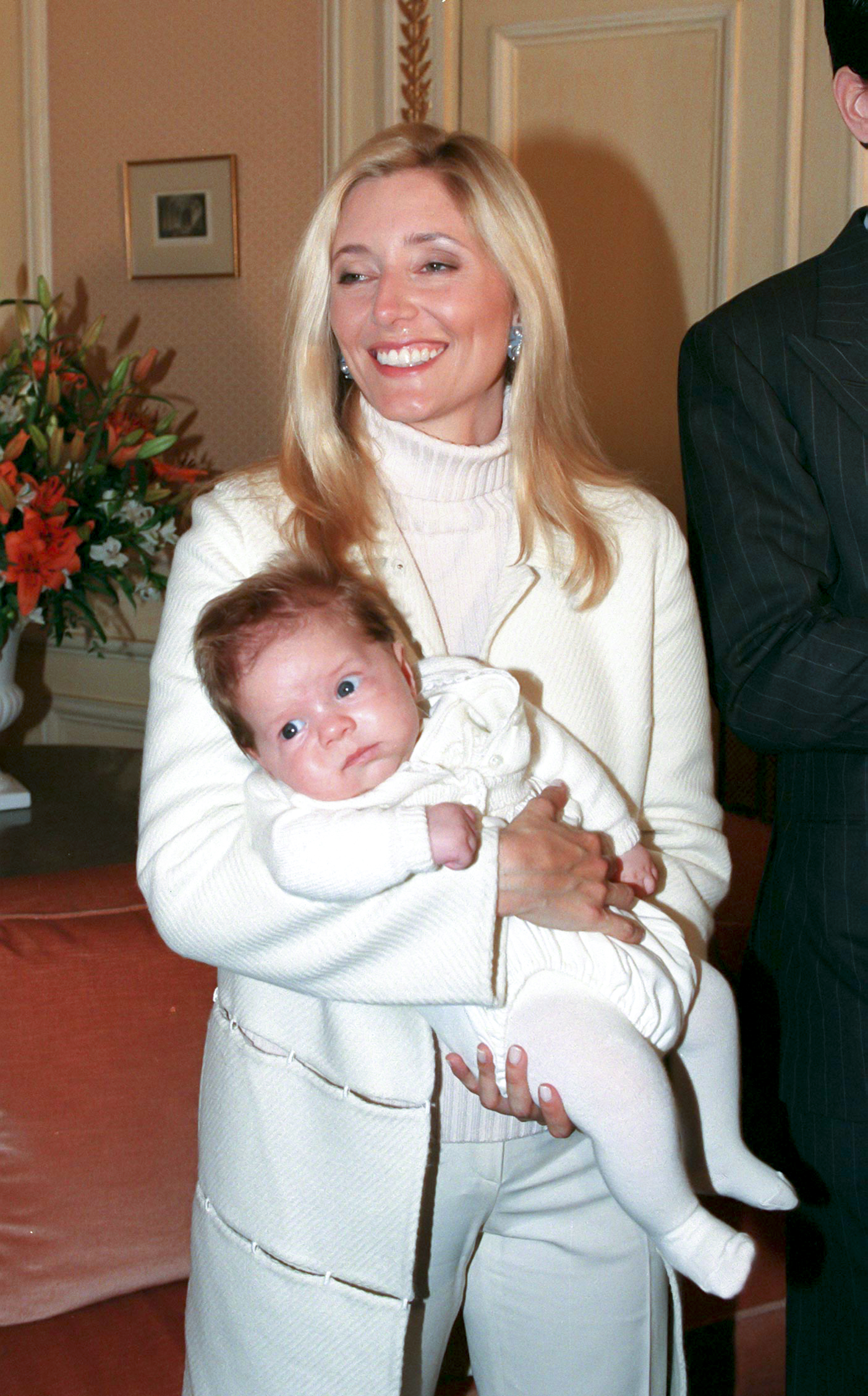 Smiling as she cradled her newborn son, Crown Princess Marie-Chantal of Greece was photographed holding Prince Constantine-Alexios during an official photocall at the Ritz Hotel in Paris. The portrait, taken in January 1999, showed the Princess just weeks into motherhood, shortly before her son's christening in London.