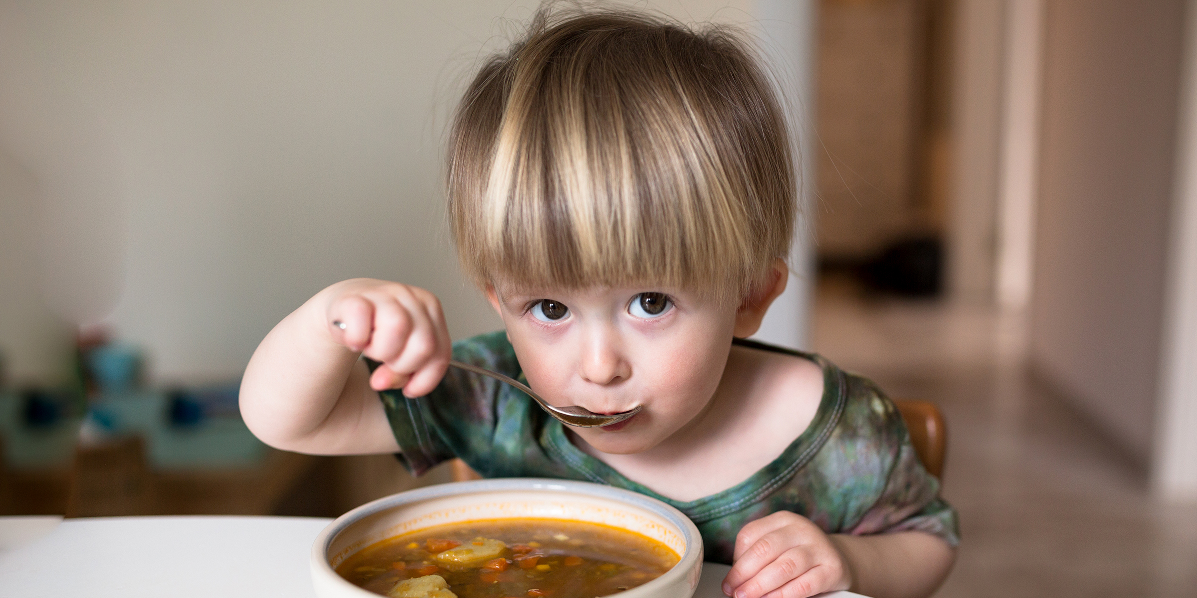 A little boy eating soup | Source: Shutterstock