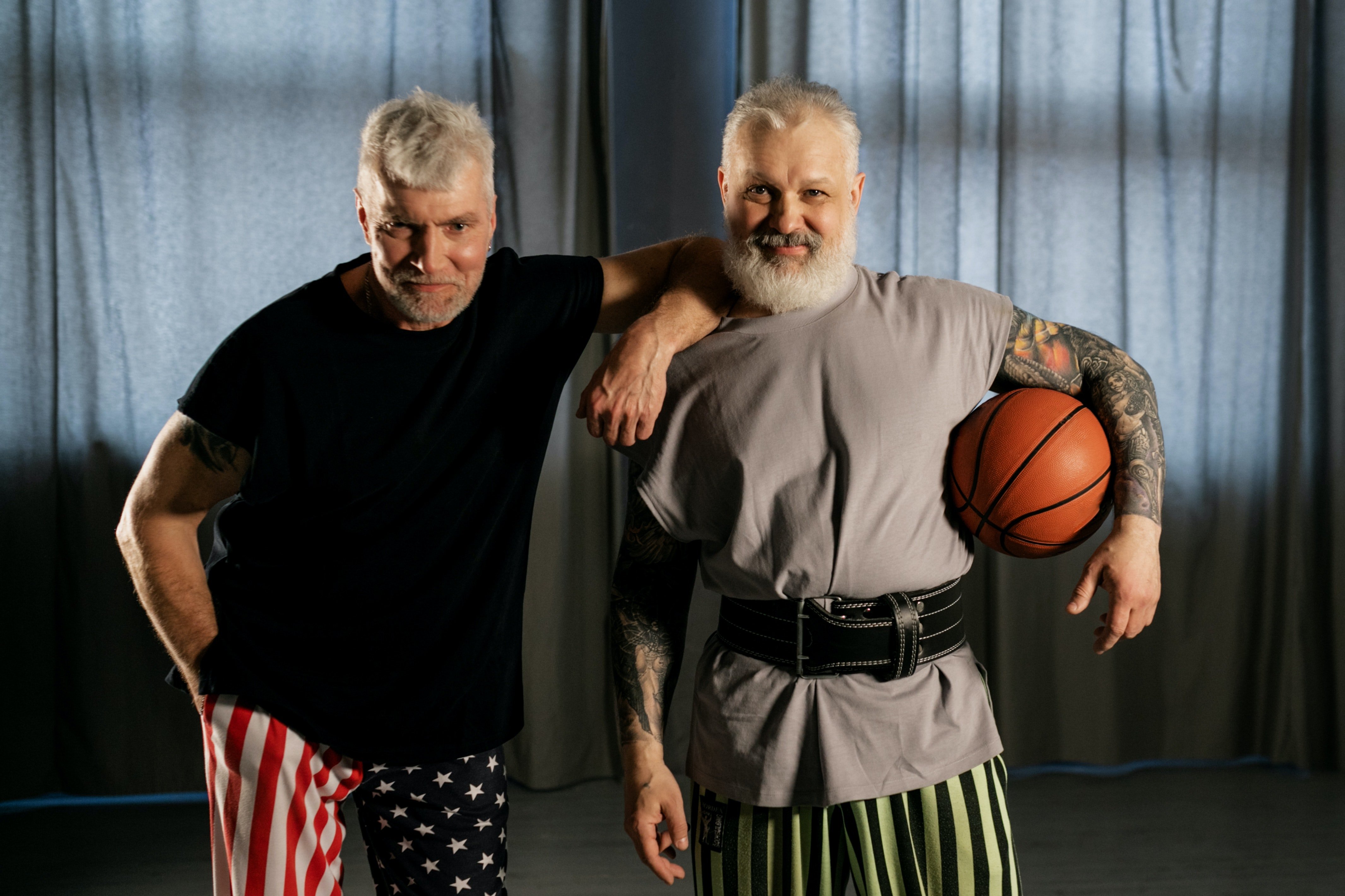 Pictured - Two elderly men smiling while one holds a basketball ball | Source: Pexels